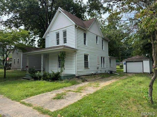 CHARMING 4-BEDROOM HOME with great character & potential! Welcome to this 1,840 sq. ft. Nokomis home, full of original amenities like hardwood floors, thick wood trim, and a built-in dining room hutch. The layout features a main-floor primary bedroom, full bath, spacious kitchen, and adjacent dining area with two additional bedrooms upstairs. Outside, you'll find a classic front porch, a large covered back patio, a level yard with shade trees, and a detached 1-car garage. With classic lines and a partial basement for extra storage, it’s a fantastic opportunity to update and make your own!