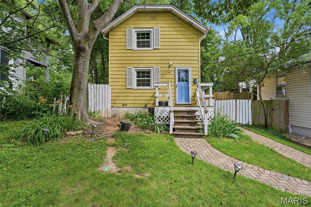 Open House Cancelled 6/21 - Fall in love with this charming, cheery yellow two-story home nestled in the heart of highly desirable Webster Groves. Offering 2 bedrooms, 1 bathroom, and a long list of updates, this home is the perfect opportunity for first-time buyers, investors, or anyone looking to enjoy one of St. Louis' most walkable and sought-after communities.

Inside, you'll find updated flooring, newer windows, and an updated HVAC system, creating a comfortable, move-in-ready space. A brand-new roof provides peace of mind, while the walk-up basement offers additional storage and flexibility.

Outside, a spacious fully fenced backyard with a storage shed provides room to relax, garden, or play, while the front of the home showcases significant improvements including a newer retaining wall, landscaping, hardscaping, and concrete work that enhance both curb appeal and functionality.

The location truly sets this home apart. Enjoy direct access to Lockwood Park via a walking path just steps from your front door, creating a rare connection to green space in the heart of Webster Groves. Convenient highway access, along with nearby restaurants, coffee shops, boutiques, and community events, makes it easy to enjoy everything this vibrant neighborhood has to offer.

Don't miss your opportunity to own this delightful home in one of St. Louis' most beloved communities. *Professional pictures will be posted Friday!*
