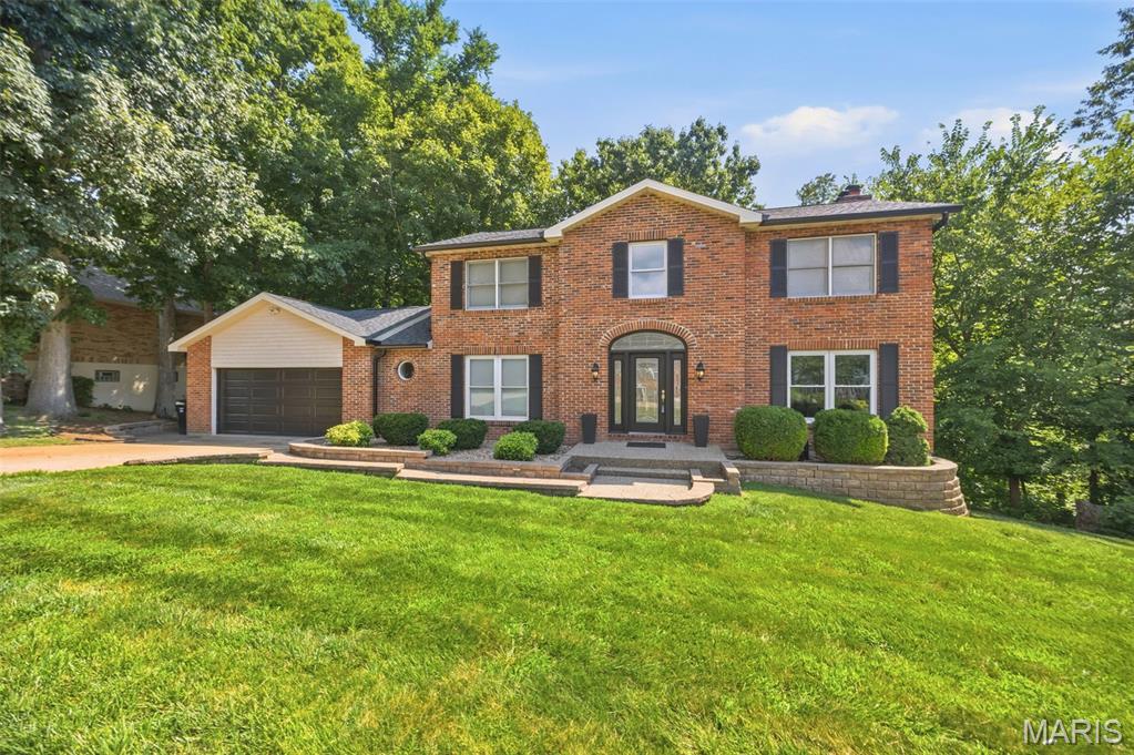 Tucked away in White Tail Trails subdivision, a small secluded highly desirable CUSTOM BUILT neighborhood in South St. Louis County, this beautifully maintained 2-story home offers the perfect combination of privacy, quality updates, and timeless charm. Nestled at the start of the cul-de-sac and backing to mature woods, you'll enjoy a peaceful setting with a truly private feel. 

Inside, you'll find 3 spacious bedrooms, 3 full bathrooms, and 1 half bath with a thoughtfully designed floor plan that's perfect for everyday living and entertaining. Upstairs, the generous primary suite is joined by two additional bedrooms and a second full bath. A charming landing overlooks the impressive foyer below, creating an open and inviting feel.

The main level features both formal living and dining rooms, along with a spacious family room showcasing stunning exposed wood ceiling beams, a beautiful brick wood-burning fireplace, and a five-window bay that fills the space with natural light. Glass doors from both the family room and kitchen provide easy access to the deck, seamlessly blending indoor and outdoor living.

The custom kitchen is a true showpiece, featuring granite countertops, a large center island with a Wolf gas cooktop, stainless steel appliances, subzero wine fridge, an eye-catching tile backsplash, under cabinet lighting and abundant cabinetry-perfect for preparing meals and entertaining. A convenient laundry/mud room and half bath complete the main floor.

The mostly finished walk-out lower level provides even more living space with a large recreation room, a versatile flex room ideal for a home office, gym, or guest space, and a full bathroom. Step outside to the concrete patio and enjoy the beautifully landscaped backyard featuring an impressive paver patio, retaining walls, and a tranquil wooded backdrop.

Major exterior updates provide added peace of mind, including a new architectural shingle roof, siding, shutters, and gutters/gutter guards-all replaced in 2025.

If you're looking for a home that offers exceptional outdoor living, quality craftsmanship, modern updates, and a private setting in a beautiful CUSTOM BUILT neighborhood, this one is a must-see!  Come take a look as this will not last long!