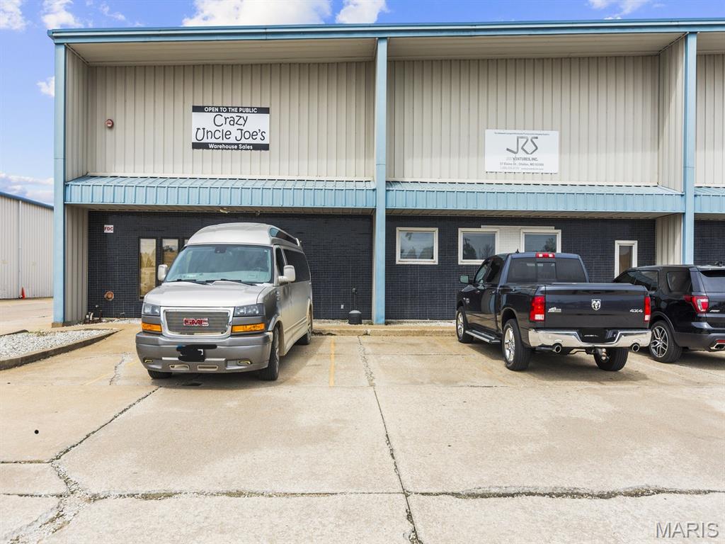 Great opportunity to own large warehouse building, over 32,000 sf of space. Large parking lot with parking in front and behind building. Three dock doors behind building, 1 drive in door, back of lot is fenced. Large warehouse space, work room, storage, conference rooms, offices, kitchen, bathroom & separated work areas.