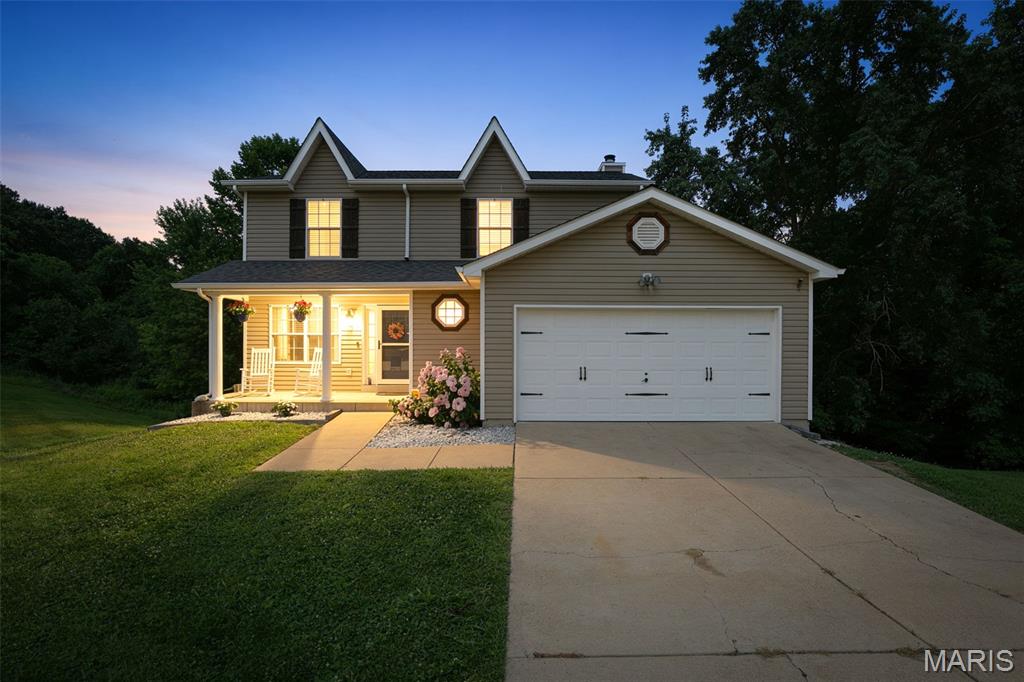 Welcome to this beautifully updated 4-bedroom, 2.5-bath home situated on a large corner lot in a quiet cul-de-sac in the highly desirable Fox School District (Seckman High School). With spacious living areas, modern updates, and a fantastic layout, this home is ready for its next owner. Step inside and be greeted by a formal dining room, perfect for hosting family dinners and holiday gatherings. A stunning oversized picture window overlooking the backyard is along the staircase and fills the home with natural light and creates a warm, inviting atmosphere. The living area is ideal for both everyday living and entertaining, featuring a cozy wood-burning fireplace as the focal point of the living room. The kitchen and bathrooms showcase durable and stylish ceramic tile flooring, while the main level has been freshly repainted and updated with new flooring, giving it a modern, move-in-ready feel. The spacious primary suite offers a relaxing retreat with vaulted ceilings that enhance the room's openness and charm. Downstairs, the finished walkout basement provides even more living space, including a family room, an additional bedroom, and a rough-in for a future bathroom, offering endless possibilities for customization. Outside, enjoy the added privacy and space that come with a large corner lot, while the 2-car garage provides plenty of parking and storage. This home is ready for YOU!