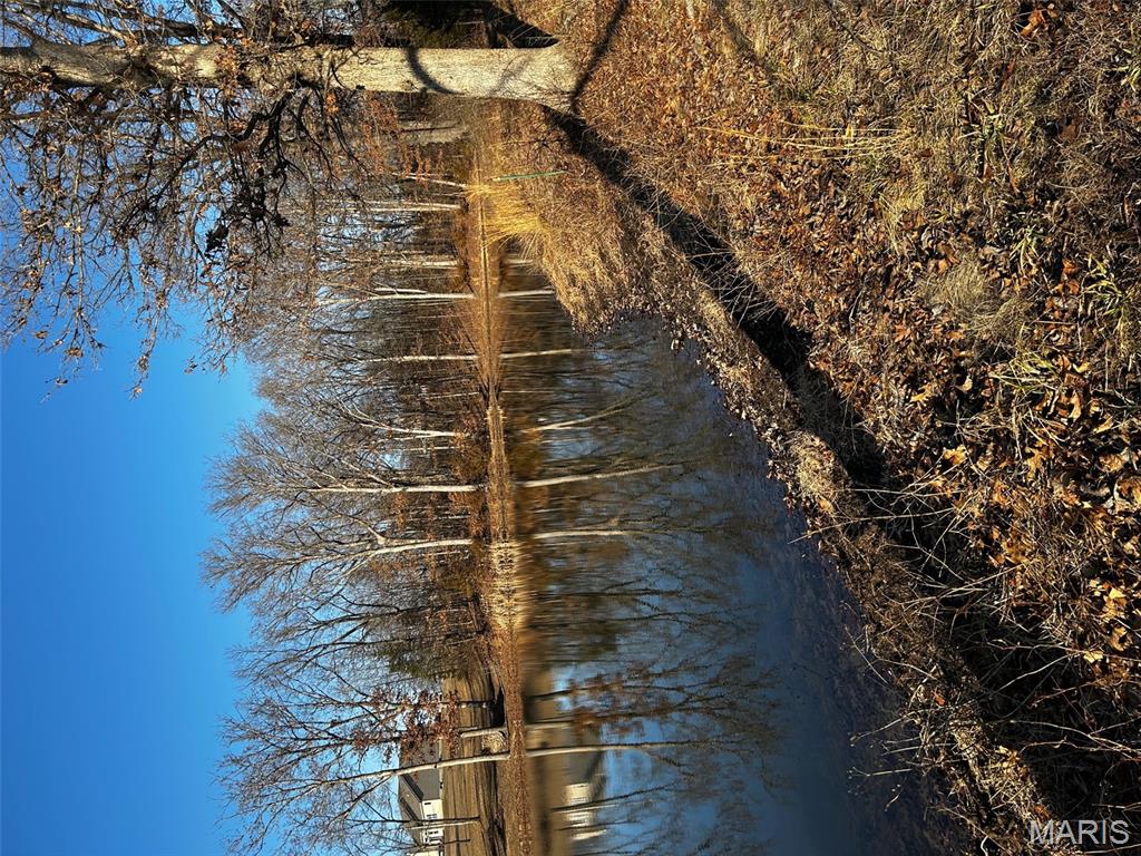 Fantastic Views backs to Pond and offers Some Towering Trees. This 3 acre Lot is definitely one of the Premium Sought After Lots in the Subdivision. Drive over the Covered Bridge and Up the Hill a little Ways. Look for the For Sale Sign! Step Out and Walk the Property. You are sure to be WOWED!  Sellers have hung on to this Beauty hoping to one day Build their Dream Home Here! Life took a different direction and after many Years & Tears Seller has opted to Sell! Admired by Many BUT could be Owned by YOU! Come make the Discovery! Buyers to confirm All Schools!!!
