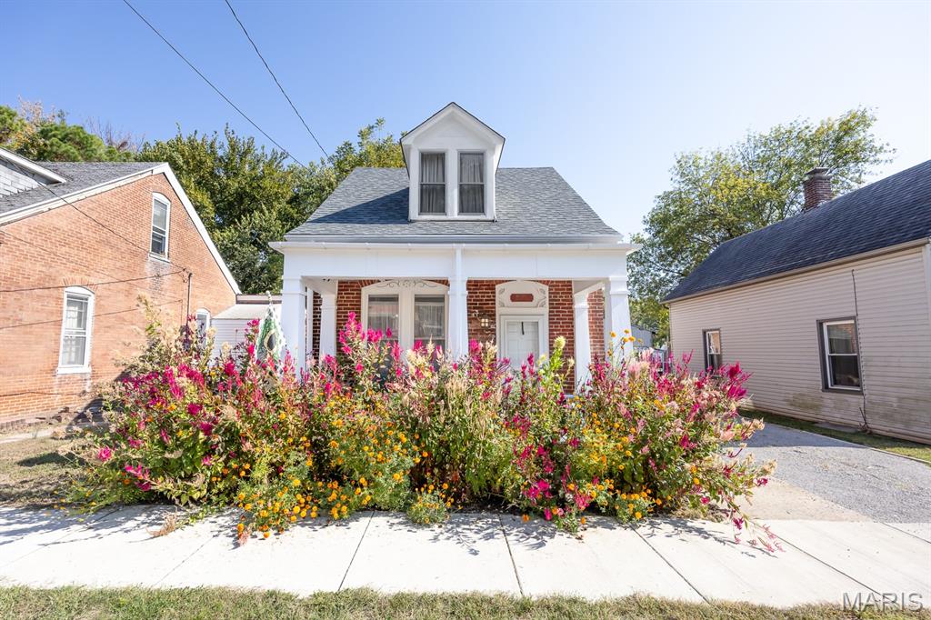 Charming historic brick German street house located in the Belleville Historic District, blocks from downtown Belleville!  This well-maintained property features a newer roof (less than 2 years old), cozy wood burning fireplace, updated kitchen with newer appliances.  Enjoy classic exposed brick in various areas throughout the house, adding character and design.  The cozy backyard has a new 6-ft vinyl fence for privacy, a 12' x 16' pergola/pavillion for parties, a large 12 x 16 newer storage shed and a designated area with fire pit and Adirondack chairs.  This home offers plenty of comfortable space inside and out! Perhaps the front covered porch is calling you to enjoy the quiet neighborhood or a retreat for for reading while you enjoy the native flowers planted in the front yard.  With Main Street just 5 blocks away, enjoy shopping, dining, or attending the nationally recognized "Art of the Square" art fair, among many of the festivals downtown Belleville has to offer. You are sure to enjoy your peaceful, quiet at 614 South Church Street. Move in Ready, has passed City Occupancy.  Please note: Audio and video surveillance are in use on this property.  Buyers & agents are responsible for verifying accuracy of all MLS data.