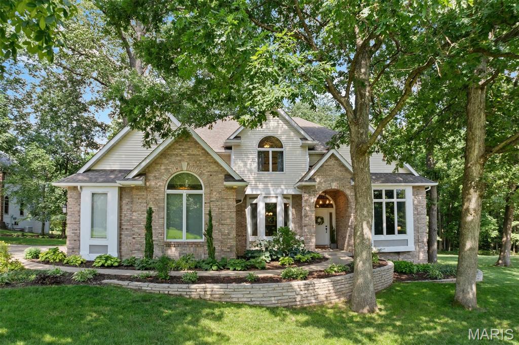 Exceptional opportunity to own this impressive home in Vintage Forest -one of the area's best-kept secrets! Situated on a stunning .68-acre wooded lot, this home offers exceptional curb appeal with a side-entry 3-car garage & beautifully maintained exterior. Inside you will be greeted by a dramatic 2-story foyer flanked by a formal dining room & elegant sitting room highlighted by stunning archways. Straight ahead, the spacious living room features a gas fireplace, custom built-ins & beautiful arched windows that frame views of the picturesque private backyard. The light & bright kitchen is designed for both everyday living & entertaining, offering hardwood floors, light cabinetry, granite counters, a stylish backsplash, SS appliances, a center island & breakfast area. Just off the kitchen, you'll find the updated laundry room with hexagon tile flooring & utility sink (washer & dryer stay) and the versatile sunroom with its many windows that showcase the surrounding wooded views – this space is perfect for a home office, reading nook or creative space. The recently renovated powder room completes the main level with a dramatic slat accent wall & updated vanity. Upstairs, the spacious primary suite provides a relaxing retreat with dual walk-in closets & a beautifully updated en-suite bath featuring a separate soaking tub, tiled shower, heated floors & private water closet. 3 generously sized guest bedrooms provide plenty of space & a renovated hall bath with updated flooring, vanity top & tub/shower surround complete the upper level. The finished lower level is an entertainer's dream-boasting a large family room with 2nd gas fireplace, more built ins, a rec space, wet bar, 1/2 bath, bonus room that would be an ideal non-conforming 5th bedroom +storage space. Whether hosting gatherings, creating a home gym, game room or guest suite, this lower level can accommodate it all! Outside, you will see what truly sets this property apart! The expansive patio overlooks the beautiful wooded backyard, creating a peaceful setting for morning coffee, outdoor dining, entertaining or simply enjoying the sights and sounds of nature. With its desirable location, thoughtful updates, flexible living spaces & incredible lot, this home truly checks all the boxes and then some. Welcome Home!