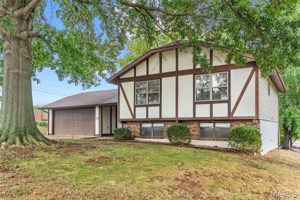 Welcome home to this spacious 4 bedroom, 2 bath split level home situated on a large lot in an established subdivision with a community pool. Conveniently located near Highway 47, schools, doctors offices, restaurants, shopping, and more. Step inside to a welcoming entry with stairs leading to the main living area. The open floor plan offers a kitchen featuring stainless steel appliances and center island that seamlessly flows into the dining and living areas, creating a great space for everyday living. Also offers three bedrooms and full bath. The walk-out lower level provides extra living space with a family/rec room, bedroom, full bath and a nice laundry/storage area. 2 car oversize garage 28 x 21. Outside enjoy the large, level yard surrounded by mature trees, and sizable patio 20 x 12, great for entertaining, relaxing or outdoor activities. With its convenient location, generous lot, open floor plan and access to the subdivision pool don't miss your opportunity-schedule your showing today.