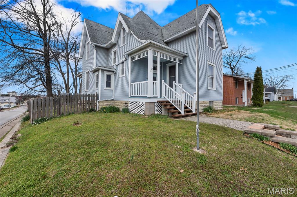 Step into timeless charm with this stunning story-and-half Victorian home located in the heart of Perryville! Perfectly situated close to shopping, dining, and everyday conveniences, this home blends classic character with comfortable living. From the moment you walk in, you’ll be captivated by the beautiful staircase in the entryway—a true centerpiece that sets the tone for the rest of the home. Inside, you’ll also find elegant built-in cabinetry that adds both charm and functionality. The home features 4 spacious bedrooms, 3 located upstairs, along with a full bath, offering a private and peaceful retreat. The main level primary bathroom offers a standing tub for soaking! With 2 full bathrooms total, there’s plenty of space for family and guests alike. All the appliances stay along with a washer and dryer. There is approx 2180 sq ft of living space.  Outside, enjoy a large backyard with endless potential—perfect for entertaining, gardening, or adding a shop or garage to suit your needs. If you’re looking for character, space, and a prime location, this Victorian gem is a must-see!