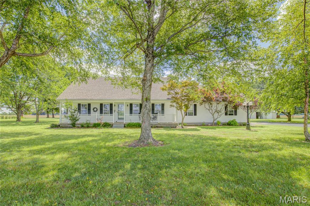 This beautiful country home is seeking new owners!! You immediately feel the warmth when you walk up to the front porch which spans the length of the home!  As soon as you enter the door you notice the open living space and beautiful details from the upstairs balcony.  This home has a great layout with the main floor having the primary and bath, living room, dining room, laundry room, and kitchen.   You will notice beautiful details in the woodwork, light fixtures, large windows, the backsplash and beautiful doors!  Now upstairs you have a landing are that can be used for an office or a common area!  Then 2 very large bedrooms and a bathroom!  This home also has a beautiful fully enclosed back porch area to enjoy those morning sunrises with a cup of coffee!  There is also a huge attached 2 car garage that will allow for even more storage that is heated!  Outside you have a great outbuilding, sprinkler system for your lawn, propane tank is owned, and a full acre!!!!  Schedule your tour today!!!