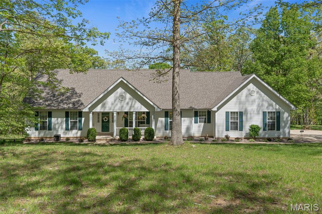 Tucked away on 15 private wooded acres, this custom-built retreat offers the perfect balance of peaceful country living and modern comfort. Surrounded by abundant wildlife—including deer, turkey, fox, and a variety of birds—this property is a true escape for nature lovers, outdoor enthusiasts, and those seeking privacy and serenity.

With approximately 2,970 square feet of finished living space, this beautifully maintained 4-bedroom, 3-bath home features warm wood flooring throughout much of the main level and a thoughtfully designed layout ideal for everyday living and entertaining. The spacious Great Room is highlighted by a striking masonry fireplace and French doors opening to a bright sunroom with scenic backyard views.

The kitchen is both functional and inviting, featuring granite countertops, a breakfast bar, double wall ovens, and a charming bay window overlooking the expansive composite deck and gazebo. Additional main-level spaces include a breakfast room, formal dining room, and cozy sitting room. The main-floor primary suite and laundry room add convenience and ease.

Upstairs, a beautifully crafted wood staircase leads to two generously sized bedrooms and a full bath—perfect for family or guests. The oversized side-entry 3-car garage offers ample space for vehicles, hobbies, or equipment, while the walk-out lower level includes rough-in plumbing, additional washer/dryer hookups, and abundant storage with endless potential for future finishing.

Step outside to enjoy peaceful mornings, serene evenings, and the beauty of your own wooded paradise from the spacious deck and gazebo. Offering a rare combination of privacy, natural beauty, and convenience, this exceptional property feels worlds away while being just 10 minutes from shopping, dining, schools, and everyday amenities.

Property Highlights
• 15 private wooded acres with abundant wildlife, hunting permitted
• Approximately 2,970 sq. ft. of finished living space
• 4 bedrooms | 3 full baths
• Stunning masonry wood-burning fireplace
• Sunroom with scenic backyard views
• Granite countertops & double wall ovens
• Spacious composite deck with gazebo
• Main-floor primary suite & laundry
• Oversized side-entry 3-car garage
• Walk-out basement with rough-in plumbing
• Additional washer/dryer hookups in lower level
• Primarily wood flooring throughout
• Peaceful rural setting just 10 minutes from town conveniences

See the “Home Improvements” list in supplements. Back on market through no fault of the seller.