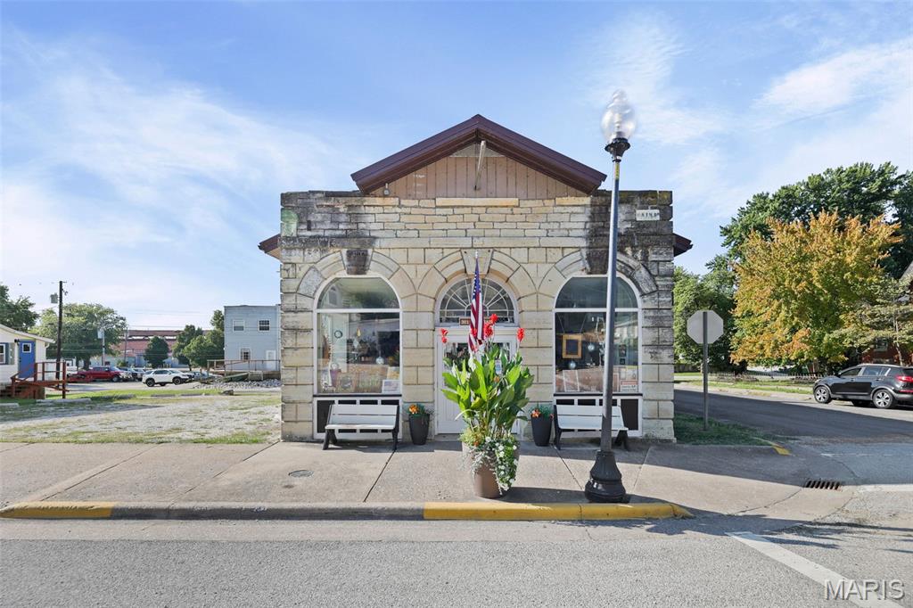 Step into Grafton’s thriving business district with this beautifully renovated historic gem built in 1860, combining timeless 19th-century charm with essential modern upgrades. Spanning 1,771 square feet on the main level, the building features a massive, light-filled showroom area, a dedicated bathroom, a flexible space for a kitchen, and a solid basement constructed with original limestone walls and flooring. Complete peace of mind comes standard thanks to recent structural and utility renovations, including a new standing seam metal roof, new furnace and A/C, new high-efficiency windows, and new gutters. Situated in a high-visibility location with breathtaking water views of the confluence of the Illinois and Mississippi Rivers, the property also includes its own private parking lot—a rare and valuable feature in downtown Grafton. Whether you have ever thought about launching your own business or are looking to capitalize on a lucrative commercial real estate investment as a landlord, this turn-key space is your chance to make it happen.
