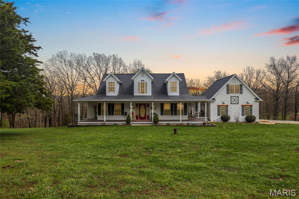 Stunning 1.5-story home sitting on 24 + acres located in the sought after Eagles Nest subdivision in St Clair! This home boasts 3 bedrooms, 2.5 bathrooms, and over 2,800 square feet including the finished, walkout lower level.

The front door opens to the 2-story entry foyer with laminate plank floors that flow throughout most of the main level and opens to the formal dining room. The formal dining features a new light fixture (2025), fresh paint (2025), and newer window coverings. The 2-story living room boasts a wood burning fireplace and opens to the kitchen.

The updated kitchen features new countertops (2025), new hardware (2025), repainted cabinetry (2025), new sink (2025), new light fixtures (2025), new tile backsplash (2025), new stainless steel appliances (2024), a center island, and dining area with a bay window.

The primary bedroom features a walk-in closet, window seat, and luxurious bathroom with a water closet, Jacuzzi tub, tile floors, and a separate shower. The powder room and laundry room with a sink complete the main level.

The second level features 2 additional bedrooms and a full hall bathroom. The finished, walkout lower level boasts a huge recreation room with a bar and ample storage space.

Other highlights include: oversized 2 car garage with a second floor storage area/bonus room, new HVAC (2021), new roof (2024), and new gutters (2024).

Relax out front on the wrap around porch or on the back patio with a hot tub, and enjoy the scenic views of the 24 + acres. The acreage features some open green space, woods, trails, and a spring fed creek. Location could not be better – close to Highway 44, restaurants, shops, schools!