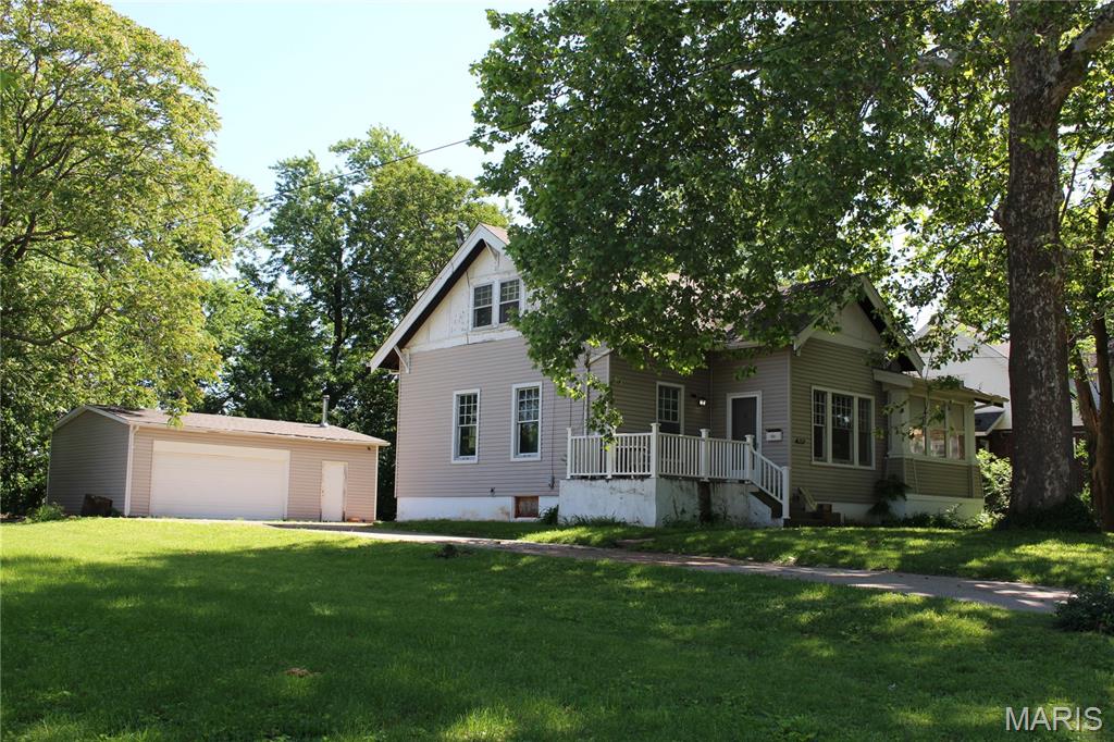 This 3 bedroom, 2 bath home with a full basement is ready for a new chapter.  A little TLC, fresh paint and fixtures will make this a warm and comfortable home for generations to come.  This historic home has the original custom millwork, including 10' baseboards and hardwood floors throughout.  The beautiful radiators still work to deliver soft, even heating throughout 2 floors and the basement, and there's a gas connection for a gas heater in the fireplace mantel to boot!  What will you do with the bright and cheery sunroom?  Outdoors you'll find a 2-car garage with a bonus workshop with heat and air, a fire pit, small greenhouse and partial fencing.  This property is listed As-Is.  Call for your private showing today!