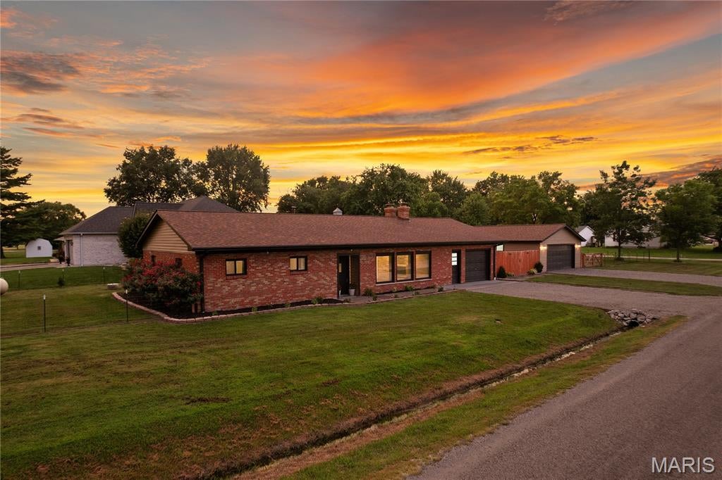 Welcome to this beautifully remodeled 3-bedroom, 2-bath home in Prairietown, IL, offering an impressive 1,906 sq. ft. of updated living space plus exceptional garage space! Thoughtfully renovated from top to bottom, this home combines modern finishes, major system upgrades, and unique character, all ready for its new owner. Step inside to a fresh, inviting interior featuring a brand-new kitchen with new cabinetry and beautiful butcher block countertops. Two fully remodeled bathrooms offer stylish, updated finishes, while a dedicated full laundry room adds everyday convenience. One of the home's most striking features is its two fireplaces, including a gorgeous real sandstone feature wall that creates a warm and unforgettable focal point. The extensive renovation goes far beyond what you can see. Major improvements include new electrical, plumbing, insulation, furnace, central A/C, roof, siding, windows, doors, and gutters, offering peace of mind for years to come. And don't miss the garage space! With both an attached and detached garage providing room for up to 3 vehicles, there's plenty of space for parking, storage, a workshop, hobbies, or recreational equipment. Nearly everything has been updated, just move in and enjoy! If you've been searching for a remodeled 3-bedroom home in Prairietown with generous living space, extensive updates, and hard-to-find garage space, this one deserves a closer look.