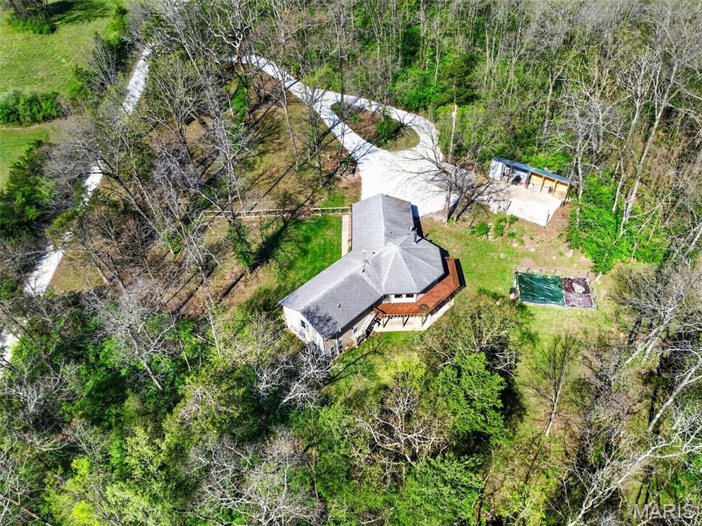 Your Private 5-Acre Escape—Where Sunsets, Pizza Nights & Garden Dreams Come to Life! 

Amazing, spacious ranch home on 5+ acres just minutes from Hwy 44 at the Pacific exit—offering the perfect blend of privacy, functionality, and convenience while keeping you close to St. Louis attractions. Inside, you’ll find custom-milled hickory floors sourced from the property and soaring cathedral ceilings. The semi-octagon Great Room features a stunning wall of windows with breathtaking views and a cozy wood-burning stove/fireplace, creating the perfect space to gather and unwind. The kitchen is open to the Great Room and features granite countertops, custom cabinetry, and a new kitchen sink—ideal for both everyday living and entertaining. The main-floor primary suite includes a newly updated bathroom suite, along with a spacious second bedroom, an additional full hall bath, and a dining area completing the main level. The spacious, finished walkout lower level offers a large family room, two additional bedrooms, and a beautifully updated full bath.

Step outside and experience a truly unique lifestyle—featuring a wrap-around deck with built-in seating, a handmade pizza oven built above the garden, and a 400 sq ft fenced garden with a stone walkway, ready for planting. Enjoy numerous edible fruit plants including peach, plum, blueberry, blackberry, and elderberry. The mostly level yard is perfect for relaxing, entertaining, wildlife watching, or simply taking in the peaceful surroundings, while the private circle driveway makes hosting easy and an expanded shed with a large firewood storage area. 

Updates include new carpet in main-level bedrooms, a remodeled primary bathroom suite, newly fenced front yard, SpringWell UV whole-house water filtration system, new water softener, new hot water heater, new garage doors, updated HVAC components, and well system improvements. Starlink internet is installed and negotiable with the sale.

A regenerative farm with a farmers market is located off the main street (Phelan). 

A rare opportunity to own a private retreat that blends comfort, sustainability, and everyday beauty.