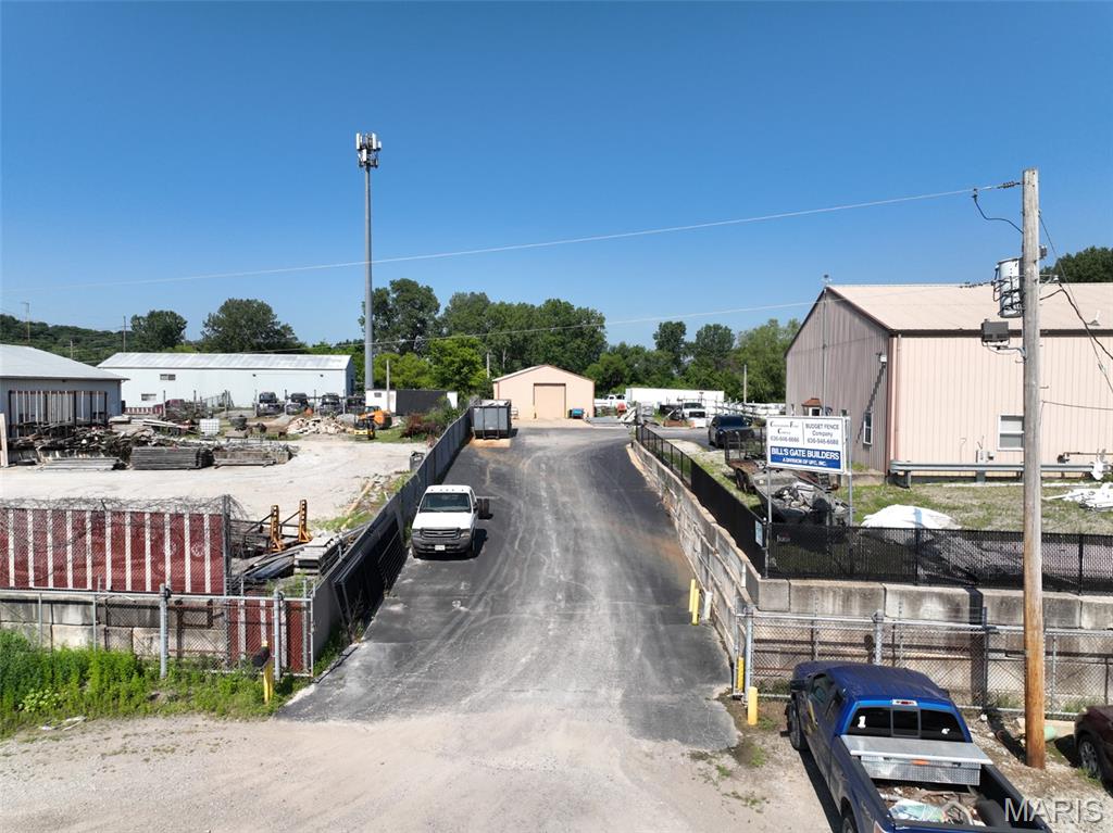 Exceptional opportunity to own a versatile 4,800 SF industrial facility situated on a fully fenced and gated 1.33-acre site in the heart of St. Charles County's established industrial corridor. Designed for efficiency and functionality, the property features a large paved truck court, drive-around circulation, extensive outdoor storage and laydown areas, ample parking, and excellent space for fleet and equipment operations.

The main building offers a flexible combination of warehouse, shop, and office space, including five private offices, a kitchen/break room, an ADA-accessible restroom, and direct access to the warehouse. Two 18-foot drive-in doors with electric openers provide convenient loading and equipment access. The warehouse includes two spacious storage bays and an approximately 1,500 SF solid mezzanine, ideal for additional storage, inventory, or workspace. Constructed with quality truss construction, the building has been well maintained and is in excellent condition.

Enhancing the property is a 30' × 40' (approximately 1,200 SF) detached accessory building, providing additional warehouse, shop, or storage space, along with a covered storage area for equipment or materials.

This property is ideally suited for contractors, roofing companies, service businesses, fleet operations, manufacturing, fabrication, distribution, equipment storage, and a variety of industrial users seeking a secure, functional facility with room to grow.

Conveniently located with excellent regional access, the property is approximately 9 minutes to Highway 370, 12 minutes to Interstate 70, 13 minutes to Highway 94, 19 minutes to Highway 364/Page Extension, 21 minutes to Interstate 64/Highway 40, and 18 minutes to St. Louis Lambert International Airport.

The property will be vacant at closing, providing a seamless opportunity for an owner-occupant or investor to immediately put the facility into service.