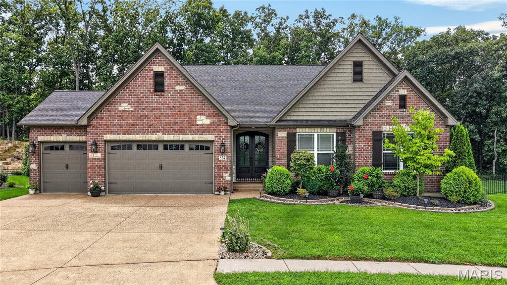 Discover this beautifully designed custom ranch, just 6 years young, in the highly desirable Wentzville North Point schools. Sitting proudly on a huge cul-de-sac with a brick front and stone accents, this 4-bedroom, 3.5-bath home delivers an open floor plan highlighted by expansive three-quarter-inch nailed hardwood floors throughout most of the main level and soaring 10-foot ceilings.
The spacious great room showcases transom windows, a wood-burning fireplace with stone surround and raised hearth, and flows into a bright breakfast room with sliding glass doors that open to a covered custom patio. All windows are 3060s, with those across the back featuring additional transoms that flood the space with natural light. The kitchen is appointed with 42” cabinets crowned in molding, granite counters, herringbone designer tile selections, Slate/GE Profile appliances including a 5-burner gas cooktop, a center island with breakfast bar, and a walk-in pantry.
The main-floor primary suite is a true retreat with a vaulted ceiling, bay window, walk-in closet, and luxury bath featuring double vanities, a walk-in steam shower, and a separate water closet. Two additional main-level bedrooms offer hardwood floors and ceiling fans.
The finished lookout basement expands your living space with a large family room complete with wet bar, a fourth bedroom, full bath, recessed lighting, and abundant storage. The private, fenced backyard backs to all woods full of Missouri wildlife and includes three five-foot gates for easy access. Additional features include a garage finished with drywall (taped and primed for paint), upgraded premium insulated garage doors, and a TV antenna in the attic with power booster.
A perfect blend of style, space, and privacy in a sought-after location.