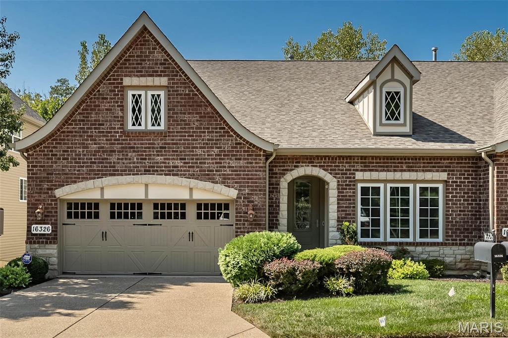 Stunning Designer Series Villa in premier Chesterfield location. This former McKelvey display features over 3000 sq ft of living space enhanced by 12' ceilings, custom trim work accents & maple hardwoods that extend throughout the main living area. Arched covered porch entrance with 8’ leaded glass door leads to gracious hardwood foyer, private study surrounded by wainscoting & bookcases and formal dining room with pass-through to kitchen.  A floor-to-ceiling stone fireplace flanked by built-in bookcases & dramatic wall of windows set the tone for the spectacular great room. The designer kitchen featuring Cambria quartz countertops, custom maple cabinetry with transom cabinets, KitchenAid appliances & stacked stone cooking alcove adjoins the light-filled breakfast room creating an ideal space for both everyday living and entertaining. The coffered primary bedroom suite offers an appealing retreat with customized walk-in closet & luxury bath with soaking tub. Lower Level entertainment space includes expansive recreation room with wet bar & brick fireplace plus 2nd bedroom & full bath. Sliding glass doors open to the outdoor living area with screened deck with stone fireplace and covered patio.