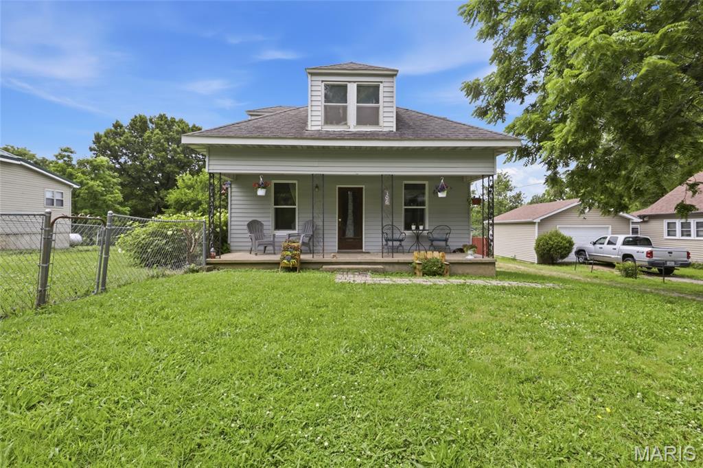 Welcome to this charming 3-bedroom, 1.5-bath home in the heart of Iberia, Missouri, where timeless character meets everyday comfort. Move-in ready and full of warmth, this inviting home offers the perfect blend of classic charm and practical living. Start your mornings on the welcoming covered front porch with a cup of coffee, then step inside to discover a home filled with personality. Beautiful hardwood flooring in select areas adds warmth and character, while the spacious layout provides comfortable living for family and guests alike. Upstairs, a versatile loft area offers endless possibilities—create a home office, reading nook, playroom, or hobby space tailored to your lifestyle. Outside, the fenced backyard provides room for children, pets, gardening, or entertaining. The detached garage offers convenient parking and storage, while the additional outbuilding is perfect for a workshop, lawn equipment, or extra storage space. Whether you're searching for your first home, looking to downsize without sacrificing charm, or simply wanting a move-in ready property in a welcoming small-town setting, this home checks all the boxes. Conveniently located in Iberia, you'll enjoy the peaceful pace of small-town living while remaining within easy reach of nearby amenities. Don't miss your opportunity to own this character-filled home. Schedule your private showing today