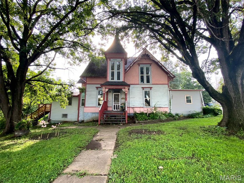 Step into history with this beautifully preserved 1½-story gem that perfectly blends timeless charm with modern comfort! Nestled on nearly 2 acres inside city limits, this rare property offers a peaceful country feel without giving up in-town convenience.

Inside, you’ll find 3 spacious bedrooms, 3 bathrooms, and two versatile bonus rooms—ideal for a home office, hobby space, or guest suite. The warm character of the home shines through its historic architecture, rich wood details, and inviting floor plan designed for both gathering and privacy.

Outside, the possibilities are endless! A detached garage provides ample parking and storage, while the classic livestock barn is ready for your animals, workshop, or creative restoration project. The sweeping yard offers space to garden, entertain, or simply relax under the open sky.

Whether you’re dreaming of small-town homesteading, hosting events, or owning a piece of Missouri history, this unique property delivers it all—location, land, and limitless potential!