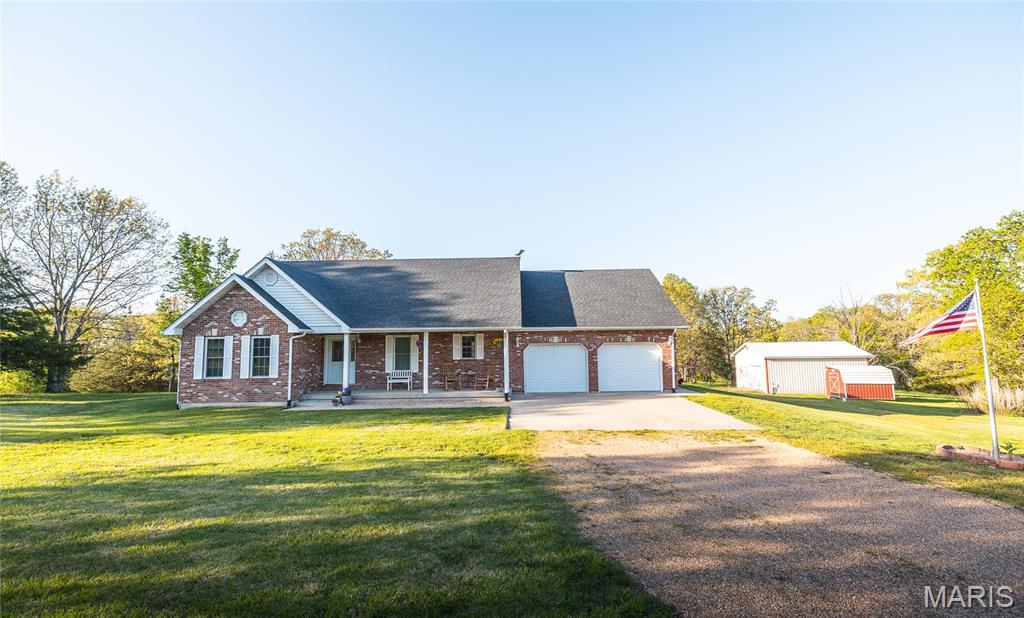 Discover the perfect blend of privacy, quality, and functionality on this stunning 11.5-acre property. This one-of-a-kind, all-brick home is built to last and offers peaceful country living with the convenience of blacktop road access all the way to the driveway.
Step inside to a warm and inviting main level featuring beautiful hardwood floors, an open-concept layout, and a well-appointed kitchen complete with stainless steel appliances. The split-bedroom floor plan provides added privacy, with a spacious master suite offering a walk-in closet and a large en-suite bath with a relaxing jacuzzi tub.
Enjoy year-round views of the backyard from the heated and cooled sunroom—perfect for morning coffee or unwinding in the evening. The partially finished walkout basement adds valuable living space, including a second family room, small office, updated half bath, and ample storage.
Outside, the property truly shines. A large patio overlooks the scenic acreage, complete with a peaceful pond, wooded areas, and trails to explore. In addition to the attached 2-car garage, you’ll find a bonus detached garage with concrete floors and electric—ideal for hobbies, equipment, or extra storage.
Well-maintained and move-in ready, this rare property offers space, serenity, and versatility. Don’t miss your chance to make it yours!