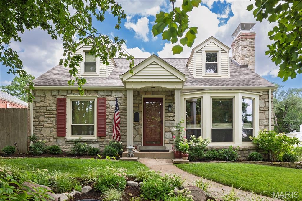 This super charming brick and stone cottage home in highly desirable Webster Gardens has many wonderful amenities! A spacious living room with floor to ceiling bay window, gas fireplace, built in bookcases and refinished hardwood floors in 2024. Then the dining room with a large bay window brings the outdoors into the room. In addition there is a private first floor guest bedroom with a full bath.
Updated Kitchen has a great layout and amazing cabinet storage and within this space you will find another gas fireplace. The kitchen opens into the sun room/family room with windows that overlook the beautiful backyard with lovely landscaping and a small stream flowing into a beautiful pool.  This is a perfect summer party house with the jacuzzi, pool, pergola and bar with sink. Upstairs has two very generous bedrooms with large closets and glass doors which open onto the terrace that overlooks the fabulous backyard! So many updates - newer fencing, new decking and railing on upstairs terrace (’24),  HVAC (’24), new roof (’24), and a recently installed concrete drive (‘24). The pool has numerous updates, a pump in ‘ 24, pool cover in ’24 and a new salt generator ‘25. There is an inground sprinkler system to care for all of this lovely landscaping. Wow! This is a GEM! Showings begin Saturday 8/15.