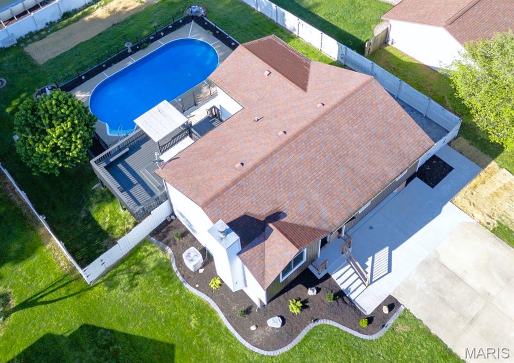 Stunning 3 bed / 3 bath home, loaded with stylish modern updates.  Located in an established Maryville IL subdivision. Over 1900 sq ft of living space. But let's start with the real star of the show. A privacy fenced oasis backyard with impressive multi-tier deck, overlooking a crystal clear inground swimming pool with newer liner, surrounded by its own attractive wrought iron fence. There are stairs & a rail leading into the 3 ft deep end, with 8 ft deep on the far end. There's also a pool house addition on the back of the home with easy access. Will you convert it into a Tiki bar w/ a changing room or use it for extra storage? The 26 ft deep, 2 car attached garage features a handy workbench area towards the back. A double gate just off the driveway opens to reveal a paved slot behind the privacy fence for storing your boat / trailer.  Inside the entry foyer, a trendy new rail & cable staircase leads you up to an open, vaulted living room w/ shiplap accent wall & woodburning fireplace. The brand new eat in kitchen features granite counters, new cabinets, breakfast bar, new stainless appliances & area for a large table. Brand new LVP flooring and carpet adorn all the rooms throughout the house. Great attention has been given to quality & detail throughout this home, including the canned lighting accents, contemporary light fixtures, faucets, ceiling fans, vanities / bowls, & door handles. The primary bedroom suite has been extended significantly. It offers a walk-in closet & private bathroom w/ shower AND also provides space for a study or lounging. 2 more updated bedrooms and a full hall bath complete the main level.  Downstairs is a big gathering room with lookout windows and a lavish new electric linear fireplace.  This large, finished space could be easily subdivided into a family room & rec room, or maybe a 4th bedroom. A convenient updated 3rd bathroom w/ shower and a finished laundry room round out the lower level. No HOA. Less than a minute from the Maryville Grade School. 25 minutes from Scott AFB. 20 minutes from downtown St Louis.