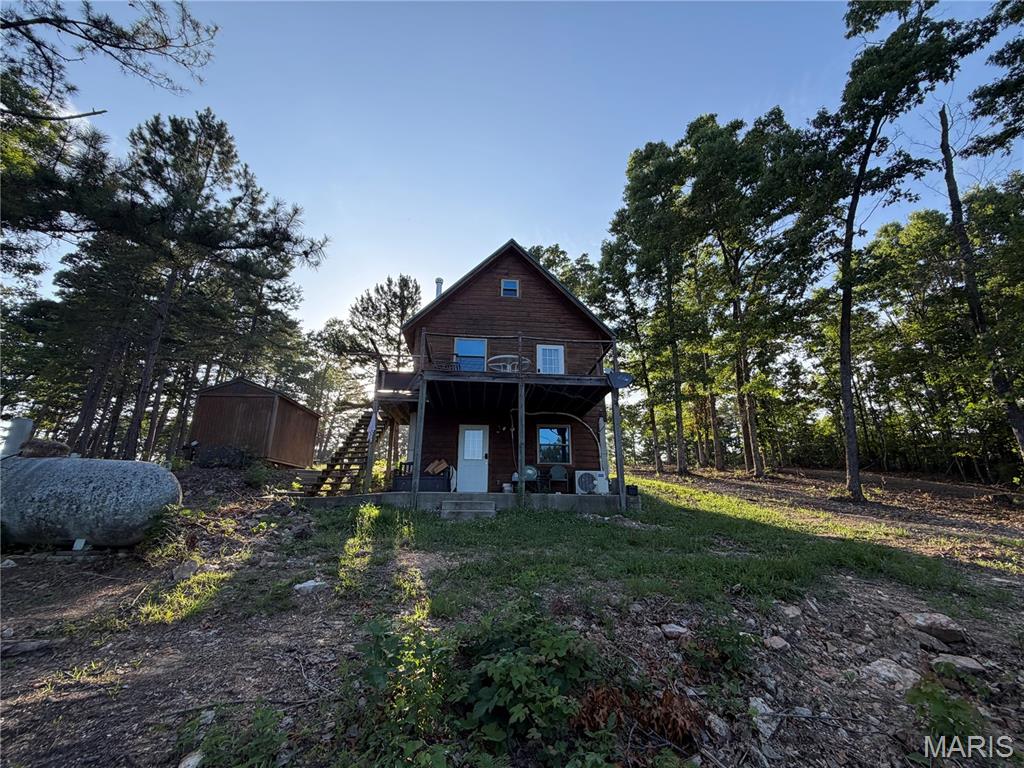 Location, Location, Location! Nestled between two of the Ozarks' most beautiful rivers near Eminence, Missouri, this 1-bedroom, 2-bath log cabin offers privacy, recreation, and endless potential. The home features a downstairs with laundry and bath room, and extra room for a sitting area or beds, a covered patio, and an outdoor deck overlooking the property. Utilities include well, sewer, and RV hookup, shed and a 40 ft Conex. Situated on 23 acres m/l, the property includes two ponds, no restrictions, and adjoins Missouri Conservation land, making it an ideal setting for a full-time residence, getaway, or recreational retreat. Located just 5 minutes from Round Spring on the upper Current River, you'll be surrounded by some of the most scenic outdoor attractions in the region. Enjoy fishing, camping, floating, sightseeing, hiking, and viewing the famous wild horses. The cold, clear waters of the Current River are one of the Ozarks' true natural treasures, with abundant wildlife, springs, and caves to explore. Horse lovers will also appreciate being just 10 minutes from Eminence, where you can access Eminence Trail Rides, the beautiful Jacks Fork River, and Alley Springs. $299,900