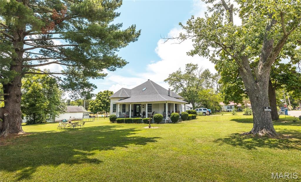 Step into the timeless charm of this beautifully restored 1940 two-story home, where historic character meets thoughtful modern updates. Offering 6 bedrooms and 3 bathrooms, this spacious home has been lovingly renovated while preserving the craftsmanship and details that make it truly special. Major improvements completed in 2024 include a new roof, skylights, flooring throughout the main level, a newly built 2-car garage, a completely remodeled kitchen, and new front and back doors. In 2021, an outdoor wood furnace was installed, with the existing propane system remaining connected for added flexibility. Original features continue to shine throughout the home, including the stunning 8-foot pocket doors, which have been carefully enclosed and preserved, the beautiful rock fireplace, and charming built-in cabinetry in the living and dining rooms. The main level offers a comfortable layout with a primary suite, two additional bedrooms, two full bathrooms, and a convenient mudroom/laundry area. Outside, you'll find a welcoming half-wraparound angled porch—the perfect place to enjoy your morning coffee or unwind with a good book. The expansive yard provides plenty of room for children to play, gardening, or entertaining, while a storage shed and the original manual water pump add both functionality and a touch of nostalgia. Rich in history, full of character, and enhanced with today's modern conveniences, this one-of-a-kind property is ready to welcome its next owners. Schedule your private showing today!
