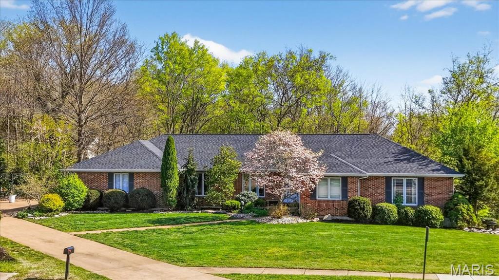 NEW ROOF , NEW HVAC, PELLA WINDOWS.... You won't want to miss this all brick, open floor plan ranch with approximately 3,500 square feet of living space situated on a stunning lot just under 3/4 of an acre. Inside, you’ll find five spacious bedrooms—each with its own walk-in closet—providing exceptional storage and flexibility. Gorgeous hardwood flooring flows throughout the great room, kitchen, dining room, sitting room, hallway, and primary suite, creating a warm and cohesive feel. The stylish navy and white kitchen is both functional and eye-catching, featuring stainless steel appliances, a coffee bar, and a center island with breakfast bar seating—perfect for gathering and everyday living. The adjacent great room offers an inviting space for relaxing or entertaining.  If you like entertaining you will love the additional space provided by the large dining room and sitting room. The generously sized primary suite includes a walk-in closet and a luxury bath with a separate soaking tub and shower. Two additional bedrooms, a second full bath, a large laundry room, and a convenient half bath complete the main level. The finished walk-out lower level expands your living space with two additional bedrooms (both with walk-in closets), a family room, game area, and a possible kitchenette setup—ideal for guests or multi-generational living. There’s also a massive storage area with potential for future finishing. And don’t miss the adorable bonus: a custom “bedroom” just for your dog! Additional features and updates include central vac system, covered patio and firepit area. Located within the highly sought-after Rockwood School District, this home also enjoys all the benefits of being within Fenton city limits, including less taxes, free weekly trash, recycling, and yard waste pickup, discounted access to the 71,000 sq ft RiverChase Recreation Center, and proximity to numerous parks and connected walking trails.  Comparing to new construction in the area, this beauty already has an impressive "option package" at no extra cost and the added bonus of being located WITHIN the city of Fenton and all its perks.