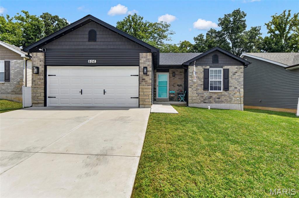Welcome home to this beautiful, two-year-old turnkey ranch offering modern style, thoughtful upgrades, and effortless one-level living. The inviting open floor plan features vaulted ceilings, luxury vinyl plank flooring, 5-inch baseboards, two-panel doors, and 2-inch faux-wood blinds throughout.

The spacious kitchen is designed for both everyday living and entertaining, featuring stainless steel appliances, a large center island, and plenty of cabinet and counter space plus the refrigerator stays! Convenient main-floor laundry includes the washer and dryer, making move-in truly easy.  The generously sized primary suite offers a peaceful retreat with a private full bath, while the additional bedrooms provide plenty of flexibility for family, guests, or a home office.

Step outside to enjoy a level, fully fenced backyard backing to mature trees, offering privacy and a beautiful natural backdrop. The home’s charming curb appeal is enhanced by a beautiful front elevation with brick accents, along with a spacious two-car garage.

The full basement provides incredible future potential, complete with an egress window and rough-in for a bathroom, ready to be finished for additional living space, recreation, or a home gym.  Residents enjoy access to a subdivision pool adding resort-style recreation right in your neighborhood.

Move-in ready, beautifully maintained, and loaded with desirable features—this one truly checks all the boxes!