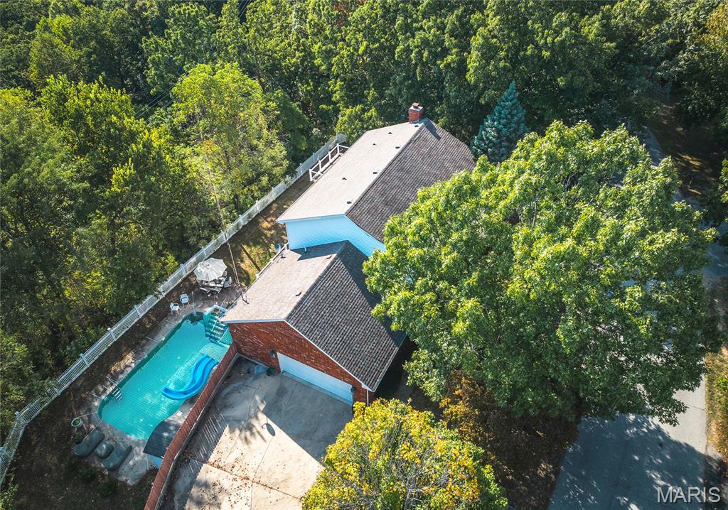 This stunning 5 bed, 3.5 bath colonial-style home sits in a peaceful neighborhood & offers the perfect blend of classic charm & modern updates. With its tall columns, inviting covered front porch & welcoming entry foyer, this home makes an impression from the moment you arrive. Step inside to find hardwood flooring throughout the main level, a bright & spacious living room, a formal dining room & a large kitchen with plenty of cabinetry & counter space. French doors lead you out to a brand-new backyard deck that overlooks the sparkling inground pool & fenced yard, creating a private retreat for relaxing or entertaining. Upstairs, the primary suite is a true oasis, complete with vaulted ceilings, natural light & a spa-like bathroom featuring a soaking tub, separate shower & dual vanities. The additional bedrooms provide flexibility for guests, family, or even a home office. Throughout the home you’ll find beautiful updates, blending style & function. The finished basement adds even more living space with a cozy wood-burning fireplace, wet bar & direct access to the patio—perfect for game nights, holiday gatherings, or quiet evenings by the fire. Outdoors, the 7.6-acre lot gives you both privacy & room to roam while still being just minutes away from shopping, restaurants & only 10 minutes to the Fort Leonard Wood front gate. This property truly has it all—elegance, comfort, outdoor living, and a location that combines convenience with peaceful surroundings.