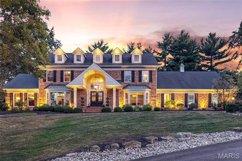 Classic-styled full brick 1.5-Sty in premier Town & Country location. This spectacular custom-built home features 7061 sq ft of living space enhanced by exceptional craftsmanship & distinctive architectural elements throughout including oak & marble flooring, soaring ceilings, detailed trim work & plantation shutters. Barrel-vaulted porch entrance with architectural pillars & double doors with wrought iron panels leads to 2-sty foyer highlighted by dramatic flared staircase, formal dining room with wide bay window and well-appointed study. Gathering bar with box beam ceiling adjoins vaulted great room with floor-to-ceiling stacked stone fireplace flanked by full-height windows. Exceptionally large kitchen with42” glazed bisque cabinetry, quartz countertops, commercial grade appliances & 12’ center island opens to sunroom with cedar-lined cathedral ceiling & atrium doors to patio. Coffered primary bedroom suite offers an appealing retreat with customized walk-in closet & spa-like bath. Front & rear staircases access3 additional bedrooms, 1 with ensuite bath & 2 with Jack n’ Jill bath, plus bonus room with custom built-ins. Level entertainment space includes family room with brick fireplace, game room with wet bar, media room, workout room & full bath. Situated on a 1.1-acre cul-de-sac lot with pavilion with outdoor kitchen, pool, stone fireplace & flagstone patio surrounded by landscaped gardens.