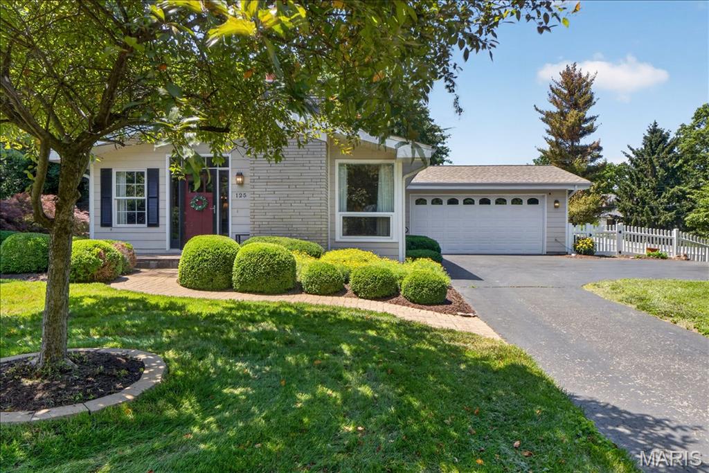 Rare opportunity to own a beautifully updated and expanded ranch situated on an incredible .72-acre lot in one of St. Charles’ most sought-after established neighborhoods. Ideally located just minutes from Historic Main Street, Lindenwood University, Hwy 70, and Hwy 370, this property offers a rare combination of space, privacy, and convenience in the heart of St. Charles. Nestled among mature trees and professionally maintained landscaping, this move-in-ready home features 3 bedrooms, 2 full baths, and a thoughtfully designed floor plan filled with natural light. The private primary suite addition serves as a true retreat, offering vaulted ceilings, abundant windows, a spacious walk-in closet, full en-suite bath, and direct access to the backyard patio. The updated kitchen features granite countertops, ceramic tile flooring, skylights, and all appliances included. The adjoining breakfast room flows seamlessly into the inviting family room, where walls of windows provide beautiful views of the backyard and fill the space with natural light. The finished lower level adds valuable living space, a large cedar closet, and ample storage. Step outside to enjoy the expansive level yard complete with mature trees, established landscaping, a water feature, spacious patio, fenced area for pets or play, and an oversized side yard offering endless possibilities for recreation, gardening, or future outdoor enhancements. Additional features include an updated full hallway bathroom, oversized extended 2-car garage, irrigation system, whole-house generator, newer roof (2025), and numerous updates throughout. Lovingly maintained and thoughtfully updated over the years, 125 Eau Claire offers a unique opportunity to own one of the area’s most distinctive properties, combining an exceptional lot, desirable location, and move-in-ready condition.