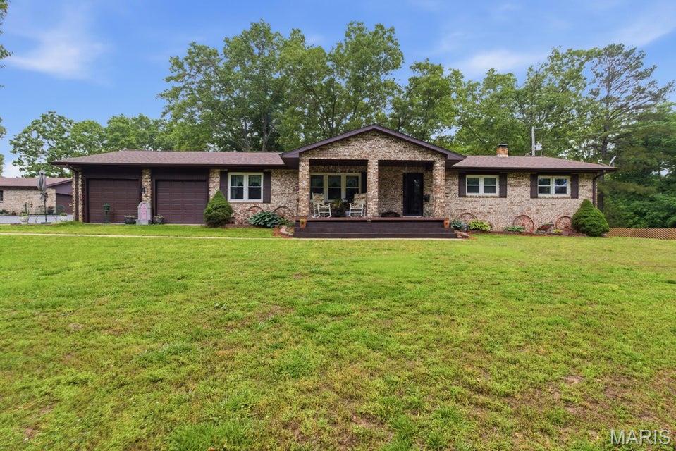 Beautiful all-brick home on 10 acres just 1 mile from Houston offering the perfect blend of comfort, space, and country living! This spacious 3 bedroom, 3 bathroom home features an attached 2-car garage, partial basement with walkout access, and an incredible amount of living space including 3 separate living rooms, a dedicated office, and formal dining room. Whether you need room for entertaining, working from home, or a growing family, this property has it all. Outside, enjoy a paved driveway leading to the home along with a detached shop, barn, pasture ground, and plenty of room for a couple cows, horses, or chickens. Relax on the covered front porch or unwind on the back deck while taking in the peaceful setting. Located just minutes from town with the privacy and space of country living, this property is ideal for anyone looking for a hobby farm or simply more room to spread out. Rare opportunity to own acreage with so many amenities in a highly desirable location!