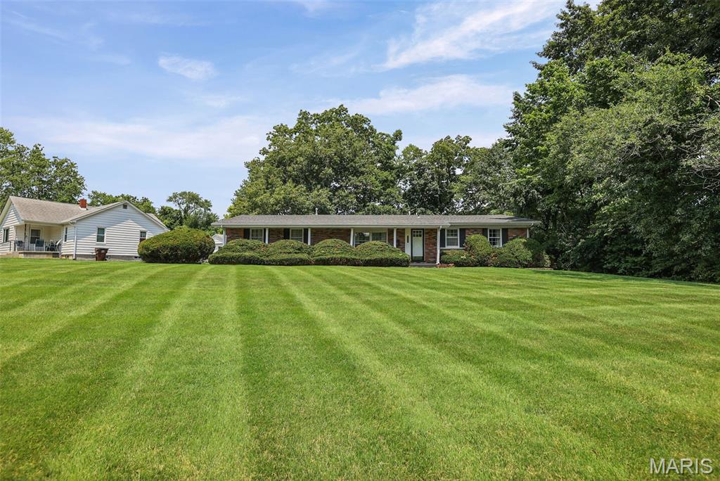Welcome home to this charming all-brick ranch situated on a spacious nearly one-acre corner lot in the highly desirable Rosewood Heights neighborhood and sought-after Roxana School District! Offering 3 bedrooms, 1.5 bathrooms, and an attached 2-car garage, this well-maintained home provides the perfect combination of comfort, character, and space. Step inside to a warm and inviting living room featuring beautiful wood ceilings with exposed beams, creating a cozy, rustic charm that’s hard to find. Outside, you’ll appreciate the large yard with plenty of room to relax, entertain, garden, or play, along with a storage shed for all your outdoor equipment and hobbies. Major updates provide added peace of mind, including all exterior doors (2026), new flooring in mud room, kitchen & first bedroom (2026), professionally installed radon mitigation system (2026), concrete lift polyjacking (2024), air duct, furnace, & evaporator coil replacement (2024), water heater (2021), roof (2017) and outdoor HVAC unit (2014). All appliances stay along with a beautiful, queen-size murphy bed cabinet in the 2nd bedroom. Whether you’re looking for your first home, downsizing, or simply wanting the convenience of one-level living on an oversized lot, this move-in-ready property is one you won’t want to miss. Schedule your private showing today!