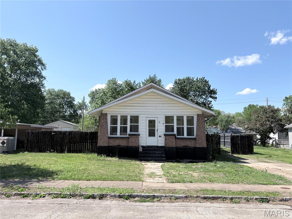 Step into timeless charm with this beautifully preserved 1925 bungalow located in the desirable St. Joseph Lead Co. First Addition subdivision in Park Hills, MO. Offering over 1,300 square feet of living space, this solid all-stone home blends classic craftsmanship with everyday comfort.
Inside, you’ll find three spacious bedrooms and one full bathroom, with a layout that feels both functional and inviting. Original character details shine throughout.  Built-in storage benches  combined with large windows that bring in plenty of natural light.
Enjoy relaxing mornings or quiet evenings on the enclosed front porch, and take advantage of the enclosed back porch for added versatility—perfect for a mudroom, hobby space, or additional seating area. The fenced-in backyard provides privacy and room to entertain, complete with an above-ground pool. 
With its durable stone construction, charming curb appeal, and convenient location, this home offers a unique opportunity to own a piece of history while enjoying modern-day living.