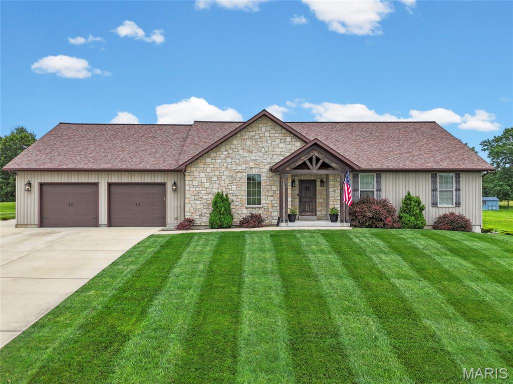 WOW, words can't express how beautiful this home is! This 2900+ square foot home on .92 acre in Hillsboro is ready for new owners.  The home's features include all the extras that every homebuyer will love.  Enter the foyer through a gorgeous wood door to a spacious living room with a vaulted wood-plank ceiling. One one side of the room is a floor-to-ceiling stone fireplace (propane) with beautiful wood floors, and a wall of windows overlooking the built-in pool and yard.  On the other side is the huge kitchen with a wall of 42” upper cabinets, a large 10’ stone island/breakfast bar, updated lighting over the breakfast bar, recessed lighting, open shelving, stainless steel appliances, a mini-fridge, and the dining room area with access to the covered patio.  The kitchen also features a huge walk-in butler’s pantry and a main-floor laundry with ample storage and shelving, plus access to the garage. Then there's the pool & patio area... WOW, the patio has a 30 x 15 built-in pool with a cover and equipment, at its deepest is 6’, and a covered patio area with a TV mount and private for entertaining. The surrounding decking is fenced and landscaped. All this overlooks the open yard with an irrigation system, which backs up to the woods, as well as a firepit area for relaxing under the stars. Back inside, the primary bedroom has a sliding glass door to the patio, a large double-rack walk-in closet with a pocket door. The primary bathroom has his-and-hers counters and an 8 x 6 walk-in ceramic shower (floor-to-ceiling) with a large bench seat. Bedrooms 2 and 3 have spacious walk-in closets. The hall bath has an oversized, deep-soaking tub, a new vanity, and new fixtures. On the main floor, every room has ceiling fans, white 2-panel doors w/white trim, and updated lighting. Downstairs is finished and features a walk-out, stained concrete flooring, a large recreation room, built-in shelving, a doggie kennel under the steps with a gate, and another full bathroom with stone flooring, floor-to-ceiling ceramic tile, and modern fixtures and shelving. The wet bar features modern shelving, ample storage, and a wood-clad wall (BAR TOP "Fenton Fire District" is to be excluded; will be replaced with a butcher-block-style top). The 2 storage areas are spacious and feature 2 200-amp services, a sump pit and pump, a water softener, shelving, and more. The garage has room for 4 cars, plus a side driveway for additional parking.  The gated community is tucked back off the main road and offers security gate (closed from 6pm-6am), 28 homes, large lots, streetlights, access to the Hillsboro School District, and public water and public sewer. You have to see this one for yourself!  All offers due by Sunday at 6 pm