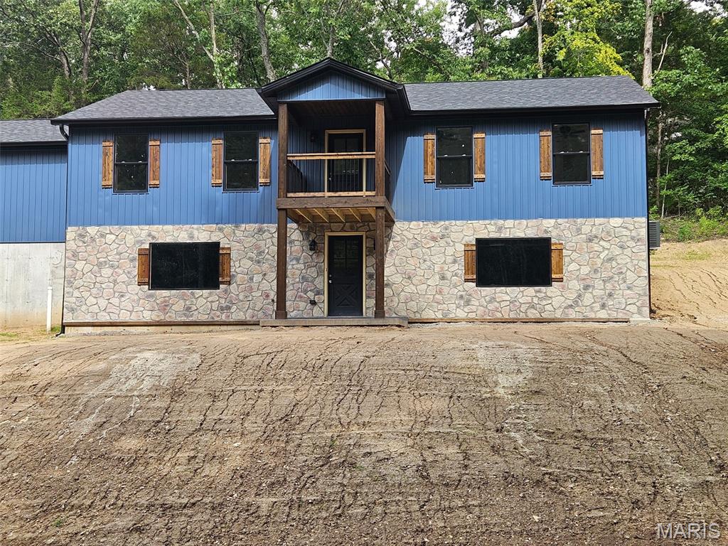 Experience the quality and craftsmanship of a custom home without the lengthy build timeline! This stunning new construction is expected to be completed within the next 30–60 days, offering the perfect opportunity to move into a brand-new home sooner. Located on just under an acre lot in sought-after Lake Wauwanoka subdivision, homeowners would experience lake life in a private, gated community. 
Designed with today's lifestyle in mind, the open-concept floor plan features soaring vaulted ceilings and picturesque wooded views from every window, creating a bright and inviting atmosphere. The spacious kitchen is the heart of the home, showcasing custom white cabinetry, granite countertops, a large center island ideal for entertaining, and a generous walk-in pantry.
The main level offers three bedrooms, including a beautifully appointed primary suite with a custom tiled walk-in shower and tile flooring. The hall bath is equally impressive with custom marble wall inserts surrounding the tub and stylish tile floors. Premium LVP flooring extends throughout the main living areas, combining durability with modern style.
Outside, you'll appreciate the charming covered front porch, attractive stone accents, and upgraded vertical siding that provide exceptional curb appeal. The walk-out basement is unfinished, offering endless possibilities and is already designed to accommodate an additional bedroom and bathroom, making future expansion simple.
Don't miss the opportunity to enjoy a brand-new, thoughtfully designed home with high-end finishes and the convenience of an accelerated completion schedule.