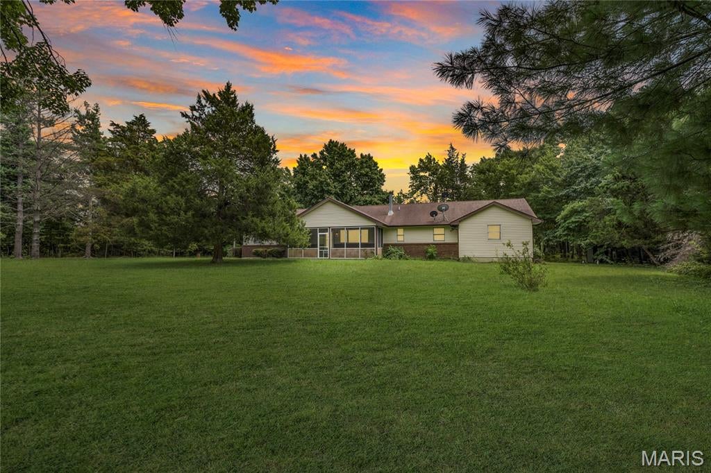 Looking for space to live, work, and play? This one delivers. Situated on approximately 3 peaceful acres, this 3-bedroom, 2-bath home offers the perfect balance of comfort and functionality. The spacious open-concept layout features a private primary suite with a walk-in closet, en suite bath, and dedicated office space—ideal for working from home or creating your own retreat. Main-floor laundry adds everyday convenience, while an outdoor wood furnace provides an additional efficient heating option. The true showstopper is the impressive 40' x 60' heated shop, offering incredible flexibility for a home-based business, workshop, equipment storage, or your favorite hobbies. Surrounded by abundant wildlife and tranquil country views, you'll enjoy the peace and privacy of rural living without sacrificing practicality. Priced under appraised value, this is an exceptional opportunity to experience country living at its finest.  Buyer to verify school district.