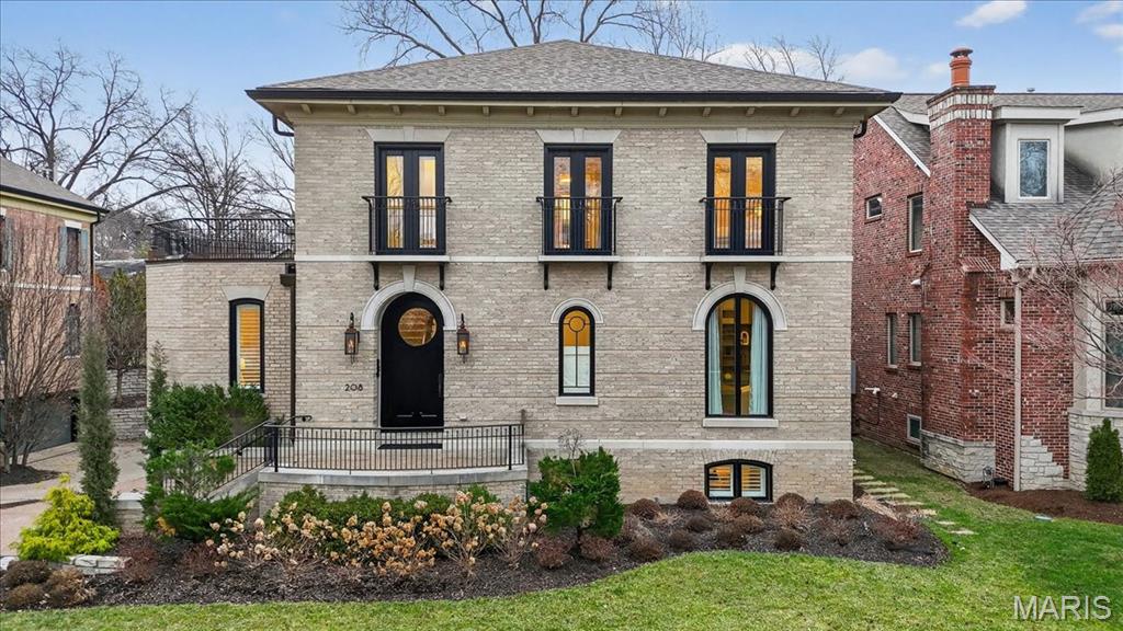 Tucked within the coveted Clayton Gardens neighborhood, this refined residence offers a rare blend of timeless elegance, thoughtful design, and effortless livability. From the moment you arrive, the home makes a statement, beginning with a dramatic entry hall showcasing herringbone hardwood floors and a sweeping staircase that sets a tone of quiet sophistication. Gracious formal living and dining rooms provide classic spaces for entertaining, enhanced by architectural detailing, custom millwork, and layered lighting. A private den with built-ins and a Palladian window offers a serene retreat for work or reading. At the heart of the home, the kitchen is both a showpiece and a gathering space, designed to be as functional as it is beautiful. Custom cabinetry, quartz countertops, a Wolf gas range with double ovens, Sub-Zero refrigeration, and an oversized eat-in island anchor the space, while seamless flow into the hearth room creates an inviting atmosphere for everyday living. A stone fireplace and wine bar add warmth and character, making this area ideal for relaxed entertaining. Glass doors extend the living space outdoors to a lush, fenced backyard that feels like a private courtyard oasis, peaceful, intimate, and beautifully designed for year-round enjoyment. An expanded patio and outdoor fireplace create the perfect setting for alfresco dining, evening gatherings, or quiet mornings surrounded by greenery. A luxurious primary suite serves as a private escape, featuring Juliet balconies and two beautifully appointed bathrooms with heated floors. One is expansive, offering a freestanding soaking tub and oversized walk-in shower, while the other is equally refined with a custom vanity, walk-in shower, and direct access to a private balcony. Generous walk-in closets and refined finishes complete the retreat. Two additional bedrooms with updated en-suite baths and a conveniently located laundry complete the second level. The walk-out lower level extends the living space with exceptional versatility, featuring a recreation room, fitness area, wine cellar, and a dedicated home theater, ideal for entertaining or unwinding at home. This exceptional home offers timeless style, modern comfort, and peace of mind, all just moments from Clayton’s acclaimed dining, shopping, and parks.