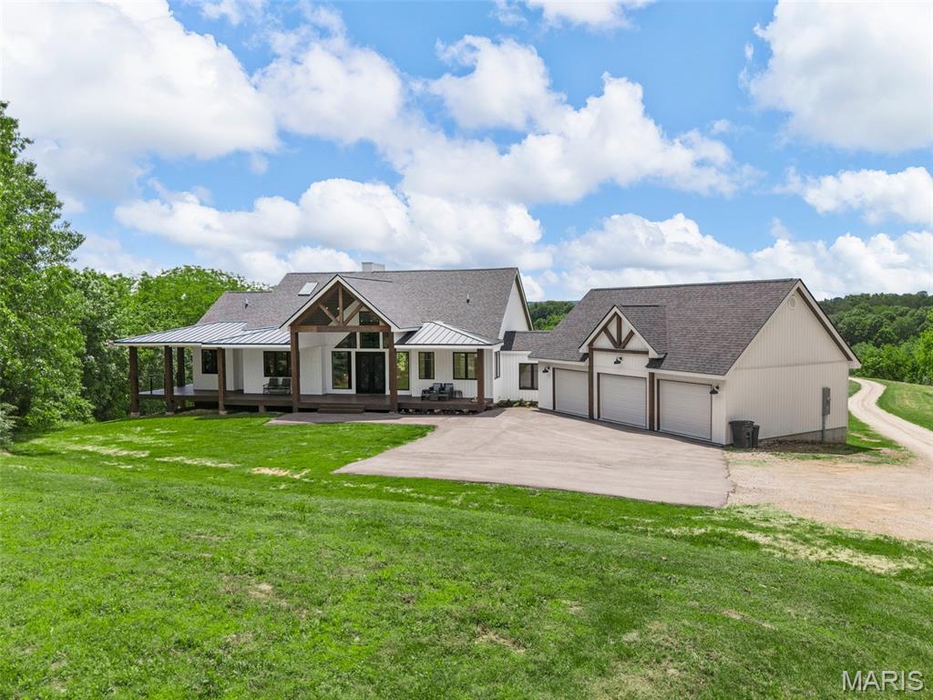Luxury 4 bed, 3 bath home with approx 4400sf on approx 22.39 acres just north of Hermann in Warren County off Hwy 94.  This 4 yr old custom built home is immaculate and Offers an Open floor plan with a Cathedral ceiling Great Room that flows into a Chef friendly kitchen. Open island with Apron Sink, Granite counters, stacked custom cabinetry, walk-in pantry, built-in wall oven with microwave and electric cooktop. Main floor laundry & adjacent private office. The Primary ensuite is grandeur with views overlooking the countryside with a private deck entry. The large walk-in closet is overshadowed by the massive lavatory with separate vanities, large jetted tub, beautiful white floor/wall ceramic tile, an oversized Glass shower enclosure with dual jetted shower-towers built for 2. The almost full finished walkout basement has 9ft ceilings & numerous full view windows. This lower level area has a recreation room, bonus area, a theatre room with a raised seating area, an exercise room (or 4th bedroom) with full view windows with incredible outside scenery -plus Another bedroom with full bathroom and glass enclosed walk-in shower. This home has a walk around covered porch with maintenance free decking, large covered patio, and a huge 25x54 -3-car garage with breezeway to the home.