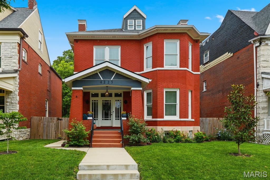 Nestled on a picturesque tree-lined cul-de-sac in the Central West End, this exceptional 1900 residence masterfully blends historic character with modern luxury. Fully renovated throughout, the home showcases timeless architectural details, including a stunning original staircase, a gracious foyer with a decorative fireplace, and hardwood flooring that flows seamlessly throughout the living spaces. Designed for both elegant entertaining and comfortable daily living, the home features dual-zoned heating and cooling and a thoughtfully updated kitchen appointed with stainless steel appliances, quartz countertops, a breakfast bar, and a convenient mudroom that opens directly to the backyard. Set on a rare double-sized lot—the largest backyard on the block—the outdoor spaces are truly extraordinary. Multiple patios, winding brick pathways, fruit-bearing trees, and raised garden beds create a private urban oasis. A covered carport and a substantial 720-square-foot outbuilding provide exceptional flexibility as a tandem garage, workshop, artist's studio, or recreational space. The expansive primary suite serves as a luxurious retreat, complete with a spa-inspired bath featuring a soaking tub, separate shower, and double-sink vanity. The third floor offers an ideal guest sanctuary with a private bedroom, full bath, wet bar, and French doors opening to a deck overlooking the idyllic grounds below. Ideally located within easy walking distance of neighborhood grocery stores, boutique shopping, and restaurants, this remarkable property offers the rare opportunity to enjoy historic elegance, modern convenience, and unparalleled outdoor living in one of St. Louis' most coveted neighborhoods.