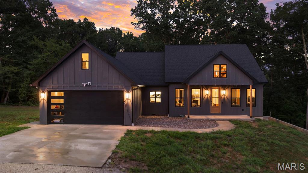 MOTIVATED SELLERS! - OPPORTUNITY KNOCKS
Tucked just off Highway 94 outside of Steedman, this exceptional new construction estate offers the perfect balance of upscale living and complete privacy. Set among mature hardwoods with dramatic rock bluffs overlooking the Missouri River bottoms, this is a property where every day feels like a retreat.
Inside, the thoughtfully designed 5-bedroom, 3.5-bath home showcases clean architectural lines, soaring ceilings, and high-end finishes throughout. The heart of the home is an impressive chef's kitchen featuring an oversized professional-style gas range, stunning quartzite waterfall countertops, and custom cabinetry including an expansive 10-foot island designed for entertaining, gathering, and everyday living. Just beyond the kitchen, a custom butler's pantry offers abundant storage, additional prep space, and keeps everyday essentials tucked neatly out of sight—making entertaining effortless.
The spacious living room is anchored by a striking floor-to-ceiling fireplace, flanked by custom built-in cabinetry that adds warmth, character, and timeless elegance. Every finish throughout the home has been thoughtfully selected to create a seamless blend of modern luxury and comfortable living.
The primary suite is a true retreat, while the additional oversized bedrooms provide generous space for family and guests. Spa-inspired bathrooms feature luxury tiled walk-in showers, designer finishes, and high-end fixtures that elevate everyday living.
Step outside and discover where this property truly shines. A multi-level composite deck and expansive patio overlook a large backyard bordered by mature hardwoods, creating the perfect setting for morning coffee, outdoor dining, or evenings spent watching deer and turkey wander through the property. Whether entertaining a crowd or enjoying the quiet sounds of nature, this outdoor living space offers a front-row seat to the beauty and tranquility of the surrounding landscape.
The mostly wooded acreage is a paradise for outdoor enthusiasts, featuring established wildlife habitat, exceptional hunting, scenic trails, and a stunning rock bluff with sweeping views over the Missouri River bottoms. It's a property that offers adventure, recreation, and privacy without sacrificing convenience.
Additional features include an attached two-car garage and a partially finished walkout basement that provides an incredible opportunity to customize the space to fit your lifestyle. Whether you envision a home theater, fitness room, game room, golf simulator, or additional entertaining area, the groundwork is already in place to make it your own.
This is more than just a home—it's a private luxury retreat where exceptional craftsmanship, breathtaking scenery, and endless outdoor recreation come together on one unforgettable property.
Whether you're looking for a full-time residence, luxury weekend escape, or recreational retreat, this one-of-a-kind property delivers an unmatched combination of sophisticated design, premium finishes, and spectacular natural beauty—all within easy access of Highway 94.

Sellers are ready to make a deal. If you've been watching this property, now is the time to schedule your showing!