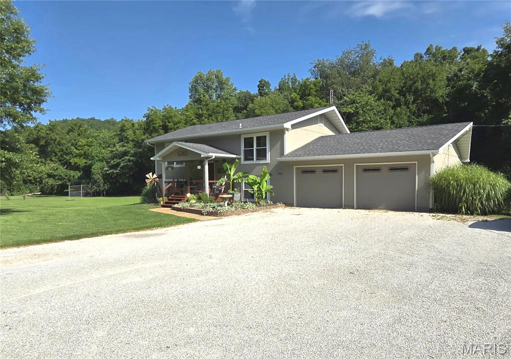 Showings start Sunday 7/19 * This home offers so much having Over 3 Acres of Beautiful land that is open and level just ready for you to enjoy!  This one can be a Homesteaders delight and its all ready to go for the new owner.  Enjoy 10 vegega ,durable galvanized raised garden beds, that are already in place and producing fruits/veggies.  Along with that are mature apple, peach and pear fruit trees .  There is even a chicken coup!  This home offers 4 bedrooms upstairs with a spacious country kitchen having a large walk-in pantry room ( once used as 5th bedroom) and a relaxing living room all on the lower/main level living area.  There is a very nice workshop with an electric sub-panel in the oversized 2 car garage with back yard access door.  The Outside space is like having your own private park setting and you can even enjoy your very own baseball backstop for the team, this is a MUST SEE!  Such a beautiful setting and a great location close to grocery shopping, restaurants and highway.   Call listing agent today to schedule your showing.