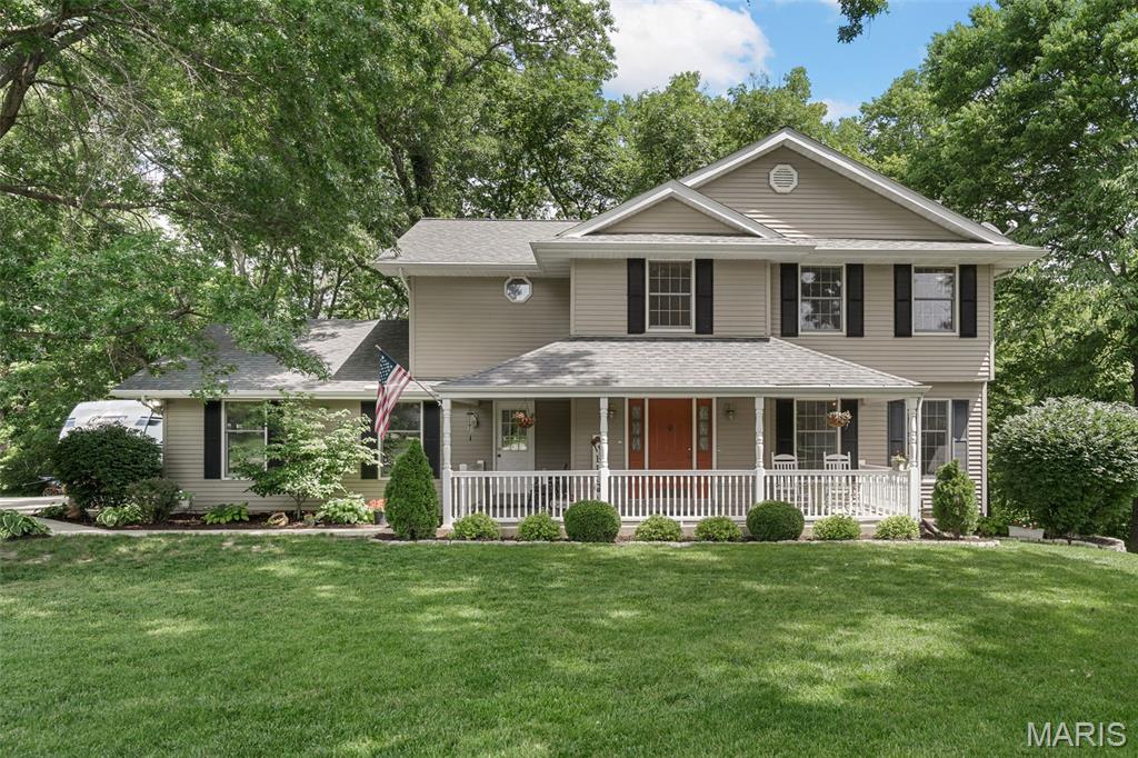 Rare opportunity! This well maintained home is on a 3+ acre lot with privacy and beautiful mature trees at the end of a quiet cul-de-sac. Location is prime, as you can enjoy absolute seclusion without sacrificing convenience, being minutes from Frankie Martin’s Garden, Cottleville boutique shops and restaurants, as well as easy commuter access to both 364 and I-70.

Step inside to a welcoming entryway with classic parquet floors that lead into a cozy living room, complete with a wood-burning Buck stove perfect for cooler weather. The main floor also features a conveniently located laundry room with side-entry, and an inviting kitchen equipped with oak cabinetry, a breakfast bar, and a wall oven. When it's time to unwind, choose between the serene screened-in porch or the deck, both offering front row seats to your gorgeous, private backyard.

Upstairs has four spacious bedrooms, including a peaceful primary suite that has a walk-in closet and an en-suite bath with a double vanity, walk-in shower, and soaking tub. A full hallway bath serves the remaining bedrooms.

The partially finished lower level adds incredible versatility, featuring a dedicated workshop, ample storage space, and walkout access to the back yard. With an existing bathroom rough-in, this lower level offers a fantastic opportunity to add value and make it your own.

The home also has an attached 2-car garage large enough to fit a truck, and a covered front porch, perfect for relaxing and enjoying the breeze or the rainfall.

You don’t want to miss this one, in today’s age they simply don’t build on 3 acre lots in a favorable location often. A clear example of this is comparing nearby neighborhoods on satellite view. This is an opportunity to enjoy the perfect blend of secluded country living and urban convenience. Book a showing today!