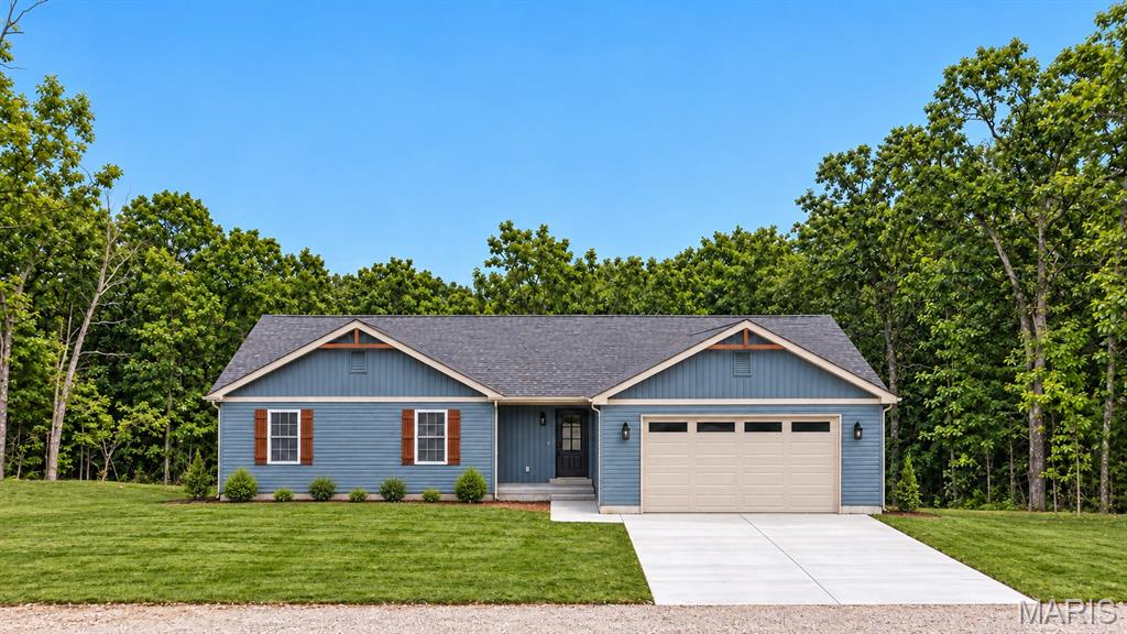 *Welcome to this pristine, move-in-ready 2026 new-construction ranch-style home featuring striking blue vinyl siding with natural wood accents and a spacious two-car garage. *Inside, a light-filled open-concept floor plan features soaring vaulted ceilings and durable LVP wood-look flooring designed for stylish, low-maintenance living. The gourmet kitchen boasts quartz countertops, a beautiful tile backsplash, and a brand-new stainless steel appliance suite. *Retreat to three comfortable bedrooms and two full baths, including custom lighting fixtures throughout that accent the home's elegant black and gold design palette. Step out onto the private back deck to grill or relax while overlooking a peaceful, wooded backdrop. *Main floor laundry is a plus for busy families. *The full walk-out basement provides expansion potential with 9-foot ceilings, a rough-in for a future bathroom, and an egress window ideal for an additional bedroom. French doors open directly to a private patio facing the tranquil woodline. *Built with exceptional craftsmanship by a premier custom builder, this home delivers peace of mind and quality in every detail.