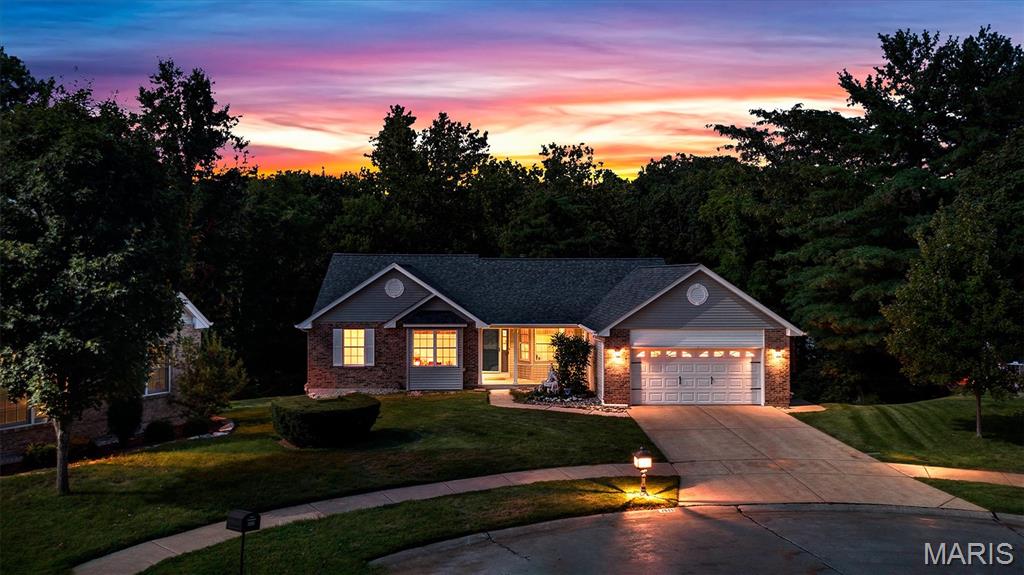 Welcome to this beautifully situated Oakville home, tucked away on a quiet cul-de-sac and backing to a peaceful wooded setting! The spacious main living area features vaulted ceilings, skylights and a gas fireplace, while the charming kitchen offers abundant cabinetry, a breakfast nook and its own vaulted ceiling. Enjoy the wooded views year-round from the enclosed porch or step outside onto the deck. The vaulted primary suite features a walk-in closet, private deck access and an impressive bath with dual vanities, skylight, separate tub and shower. Main-floor laundry adds everyday convenience. The partially finished walkout lower level expands the living space with a second gas fireplace, wet bar, full bathroom and plenty of room for recreation and entertaining. Additional highlights include an oversized two-car garage and inviting covered front porch. Major updates include a new roof in May 2026 and new furnace and air conditioner in June 2026. Two bedrooms, three full baths and a fantastic Oakville location make this home one you won’t want to miss!