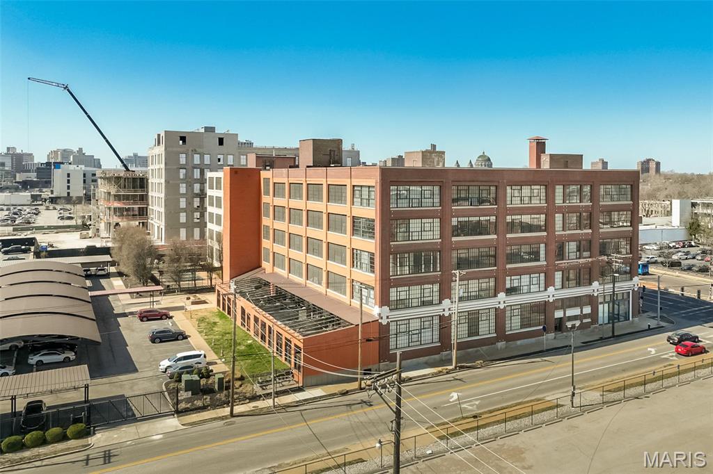 Experience elevated urban living in this stunning top-floor corner loft at West End Lofts, where industrial design meets modern luxury in the heart of the Central West End. Soaring 16-foot concrete ceilings, exposed ductwork, expansive warehouse-style windows, rich hardwood floors, and breathtaking city views create a one-of-a-kind living experience. The open-concept floor plan features a designer kitchen with Pedini Italian cabinetry, granite countertops, stainless steel appliances, and a spacious island perfect for entertaining. The oversized primary suite offers a spa-inspired bath with double vanities, separate soaking tub and shower, and a generous walk-in closet. A second bedroom and full bath provide flexibility for guests, roommates, or a dedicated home office. West End Lofts offers an impressive collection of amenities designed to simplify everyday living, including a resort-style outdoor pool, fitness center, billiards room, Amazon package lockers, secured entry, elevator access, assigned covered parking, and private storage. A dedicated freight elevator makes move-in day remarkably easy. Ideally situated between the Central West End and Cortex Innovation District, you'll enjoy a highly walkable lifestyle just moments from BJC, WashU Medical Campus, SLU, Forest Park, The Foundry, IKEA, TopGolf, restaurants, coffee shops, nightlife, and entertainment. Rent includes water, sewer, gas, trash, assigned covered parking, storage unit, and full access to the amenities. Urban convenience, industrial character, and premium amenities—this is loft living at its best!