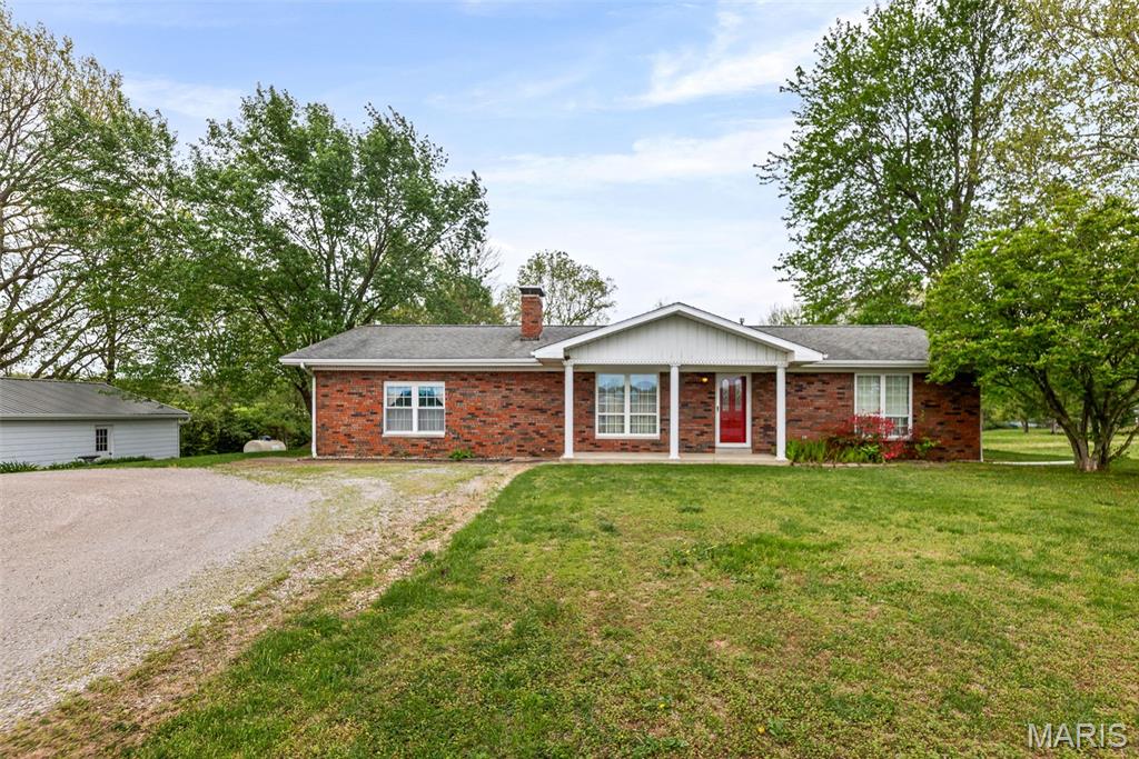 Showings begin April 17. Additional photos to be added April 16.

Country home featuring 2 bedrooms and 2 bathrooms on approximately 1.86 acres, offering a rural setting with convenient access to nearby town amenities. Property includes a spacious family room and separate living room, providing multiple living areas or potential for additional bedroom or flex space.

Kitchen includes Amish-built cabinetry and a built-in pantry. Sunroom provides additional living space with natural light and views of the property.

Exterior features include a detached 2-car garage (approximately 30 x 24) with metal roof and gutters (installed March 2026) and additional storage area within the garage. Three additional storage sheds provide space for equipment, workshop use, or hobby storage. Patio area offers outdoor living space.

Property includes a creek running through the acreage.