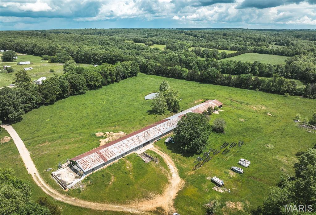 Nearly 10 acres in total with 17,000 square foot concrete block building.  Currently used for seasonal boat storage. Plenty of space for additional storage units/covered outdoor storage. This sale also includes approximately 5 acres (legal description is LT 3 PRAIRIE CREEK ESTS SEC 7-39-4) located on prairie Creek Road. There is a well and septic on site (last used in 2021). Concrete floors. Two garage doors, one in center and one on end. Included with this real estate is also a full service marina, located at a private lake in Cuba MO. That business has loyal customer base and is a land lease. The building has 3 service bays, approximately 30  boat slips for annual rental, a store/showroom (current business is a Honda marine engine dealer), and office space (one with a transferrable sub lease and private entrance). The marina business is located at 2283 Lakeshore Drive. Reference MLS#25078696 for full info.