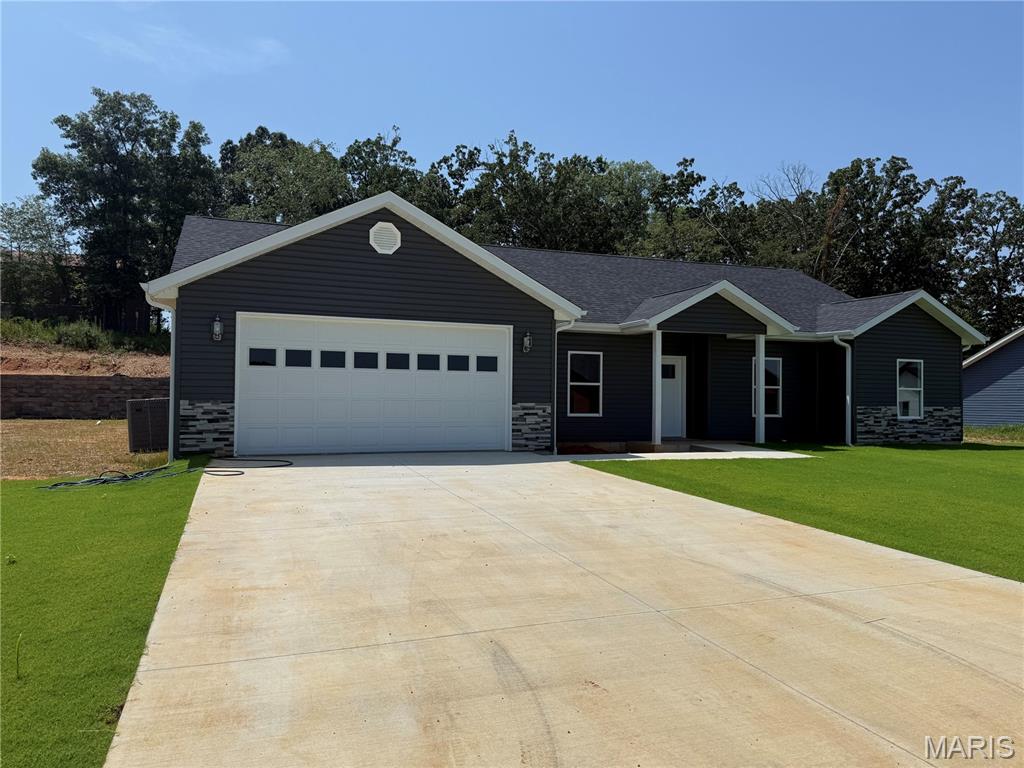 Four Bedroom Two Bath New construction home on approximately 0.40 acre m/l featuring a functional open layout and quality finishes throughout. The great room has view of back yard flows seamlessly into the kitchen and dining area, creating a bright and inviting space. Kitchen includes stainless appliances along with a walk in 7x5 pantry for added storage. Dining area provides access to the back patio through a patio door.
Split bedroom design with a spacious primary suite offering a tray ceiling, walk-in closet, and private bath with custom tile walk-in shower.
Mud room entry off the garage includes a built-in bench and storage, plus a separate laundry room with tile flooring. Home is all electric with central heat and air.
Exterior features include gray vinyl siding with rock accents, a sodded front yard, and seeded and strawed backyard. Two-car attached garage.